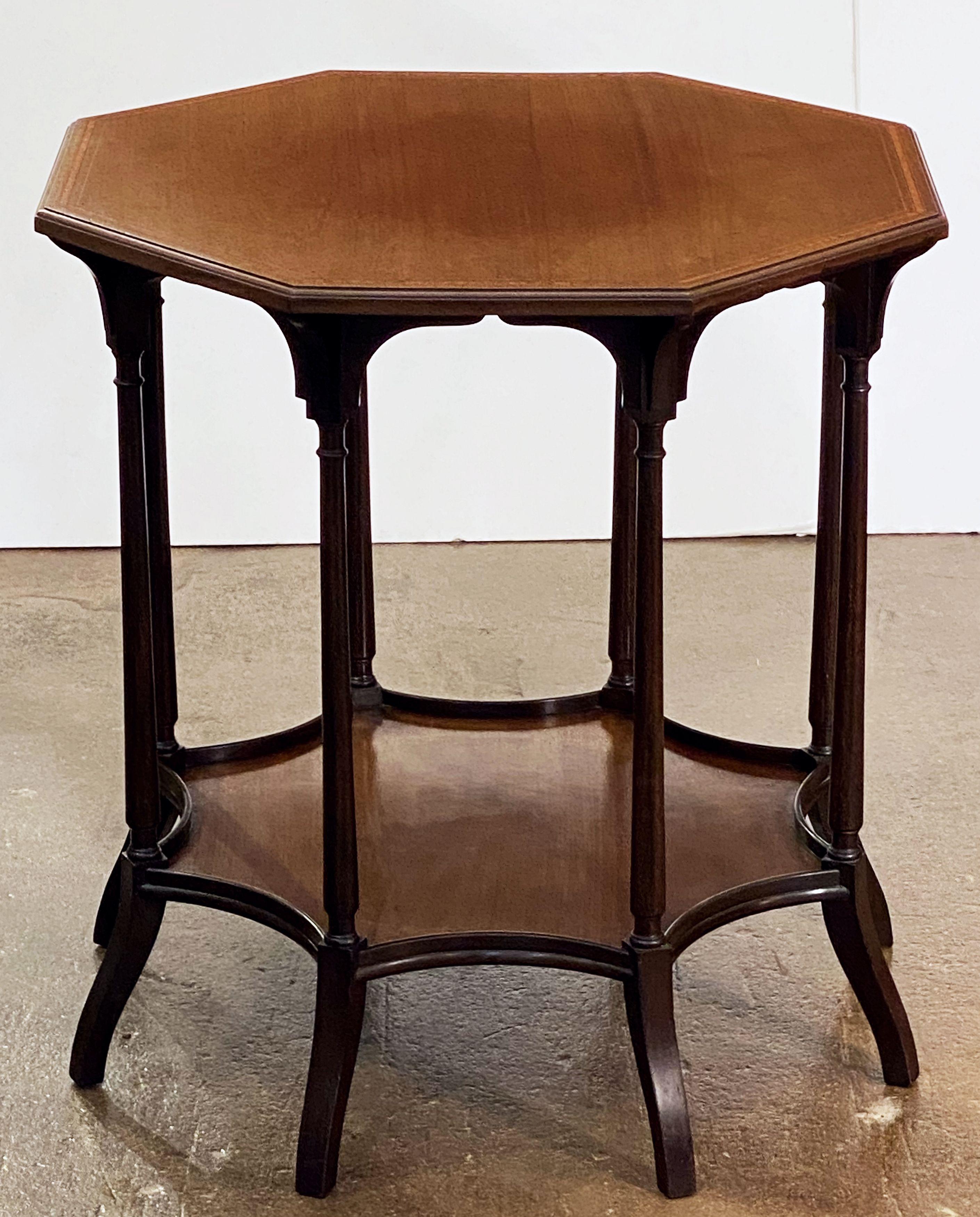 A fine English spider leg occasional table of mahogany from the Edwardian Era, in the manner of Morris & Co., featuring an octagonal crossbanded top, eight stylishly turned legs and storage shelf at bottom.
 
 