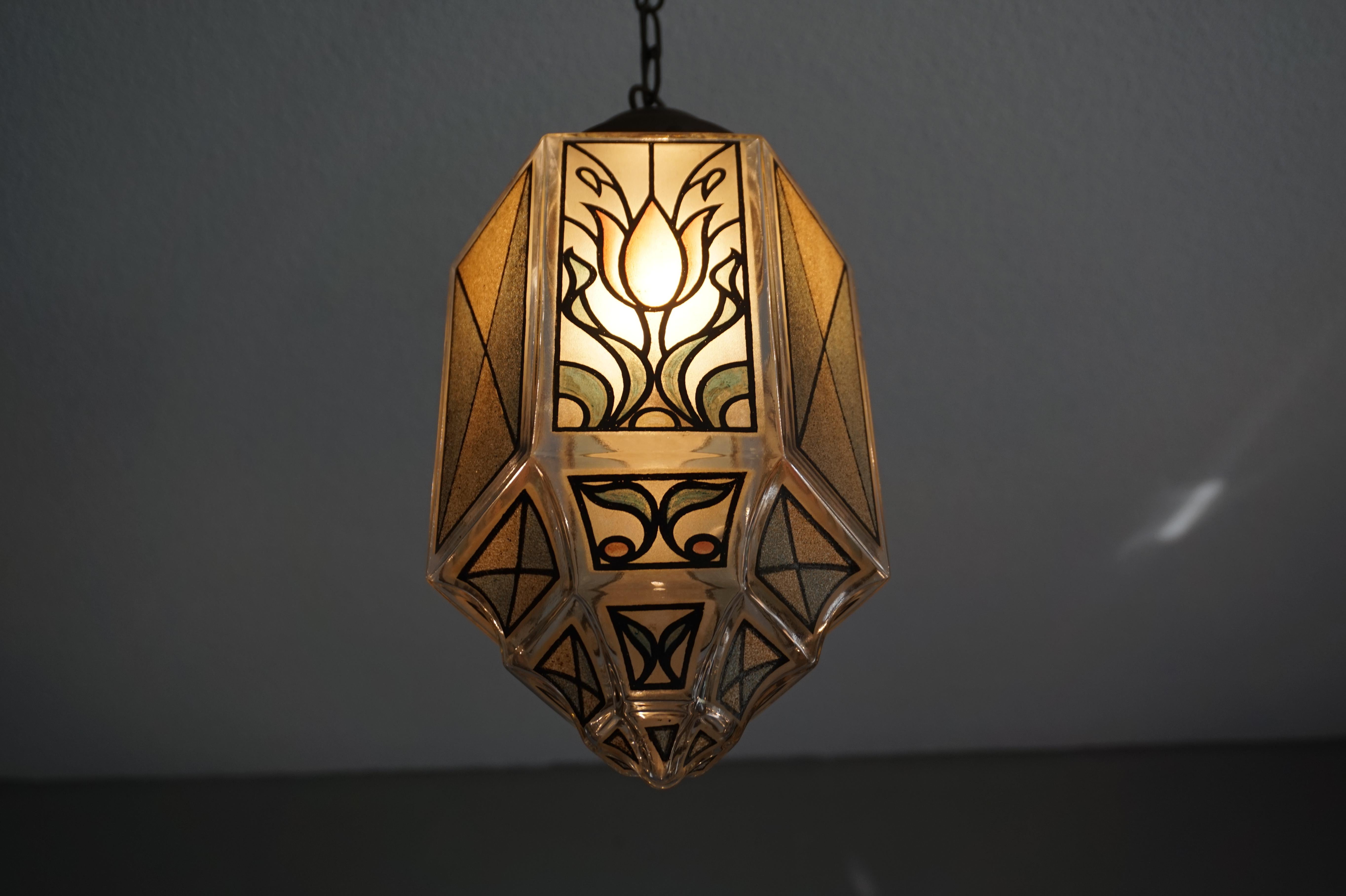 One of a kind, handcrafted light fixture with a deeper meaning.

This early 20th century pendant has everything that we look for in the antiques that we like to offer. It is artistic, it is quality made, it's got style, it's got meaning, it looks