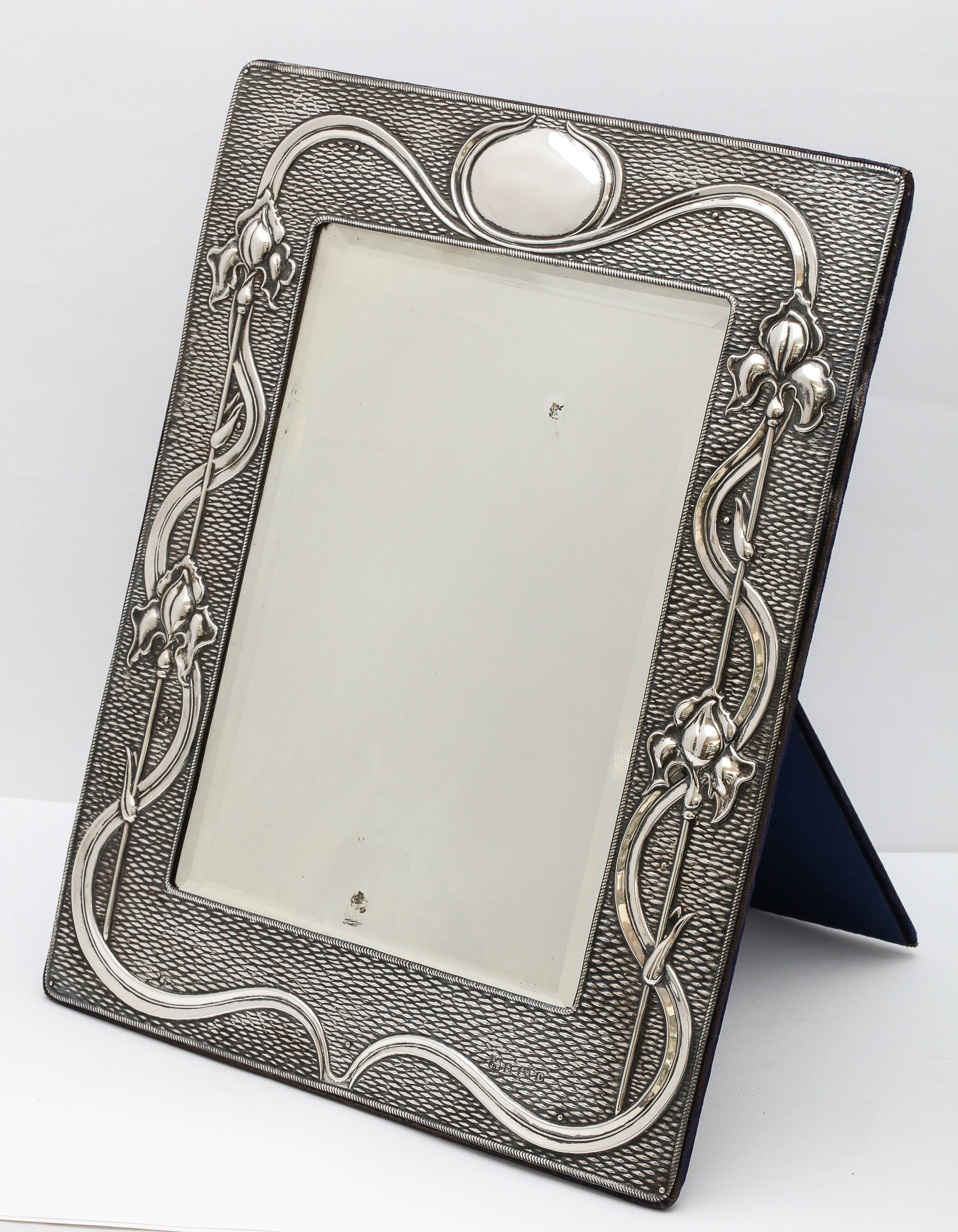 Arts & Crafts, sterling silver-mounted table mirror, Birmingham, England, year hallmarked for 1902, A and J Zimmerman, Ltd. - makers. Measures 11 1/2 inches high x by almost 9 1/2 inches wide x 7 1/2 inches deep when easel is in open position. Has