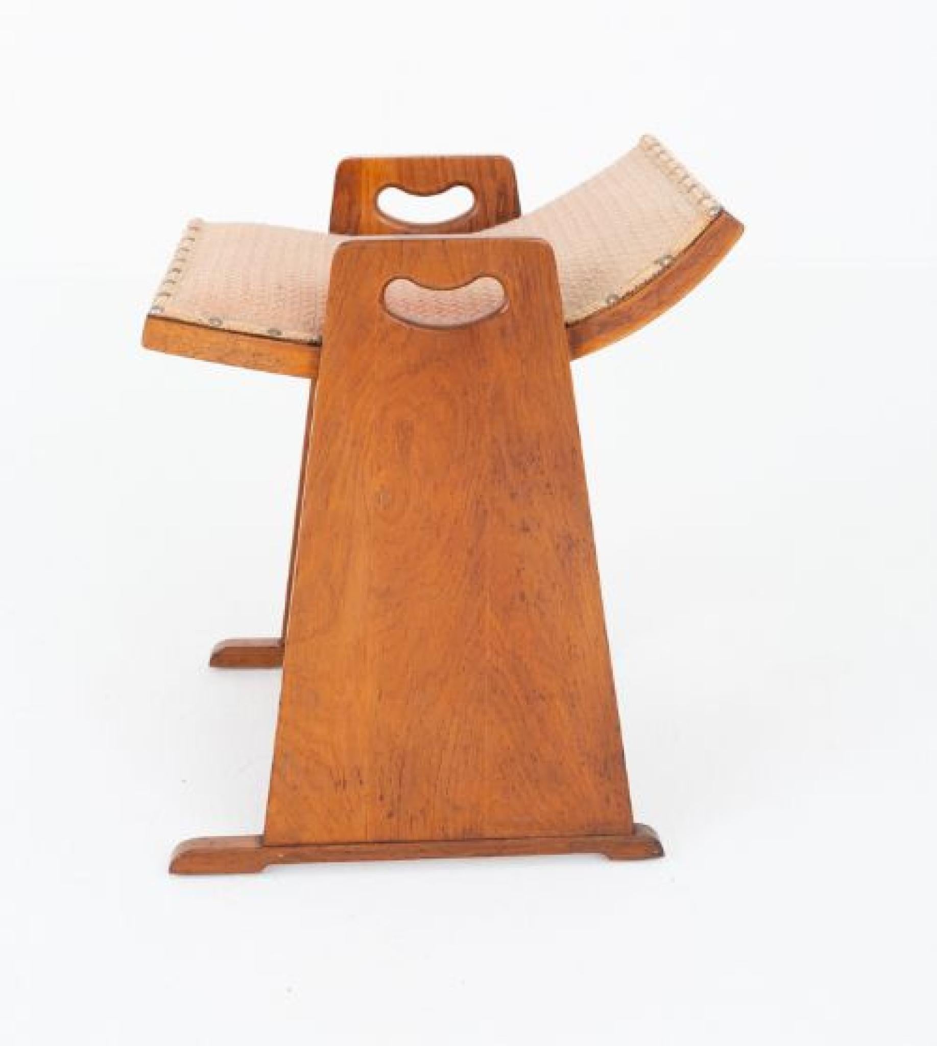 Arts and Crafts oak piano stool.
This stylish piano stool stands upon sleigh feet and features slab ends with carrying handles and a shaped seat.
Circa 1920
Will ship to anywhere in the world - including US - so please get in touch for a shipping