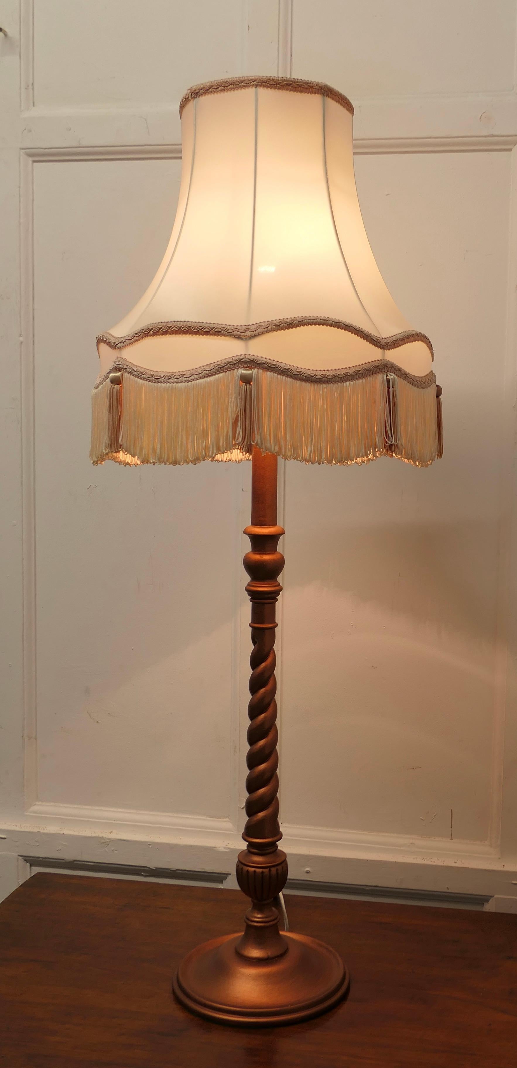 Arts and Crafts Style Half Standard Lamp

This is a very attractive piece, the barley twist turned base of the lamp has a simulated copper finished, and comes with a scalloped and tasseled shade
The lamp is in good condition and working 

The