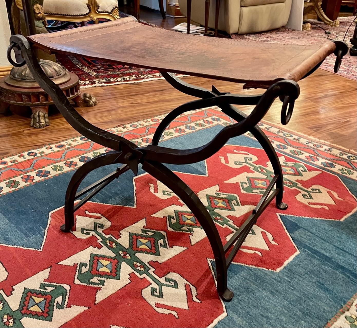 Arts and Crafts style hand hammered wrought iron folding curule seat.

Extraordinarily rare hand wrought iron and stitched leather Curule seat, handcrafted by Morgan Colt and his artistic staff. This seat, built in traditional techniques, is a