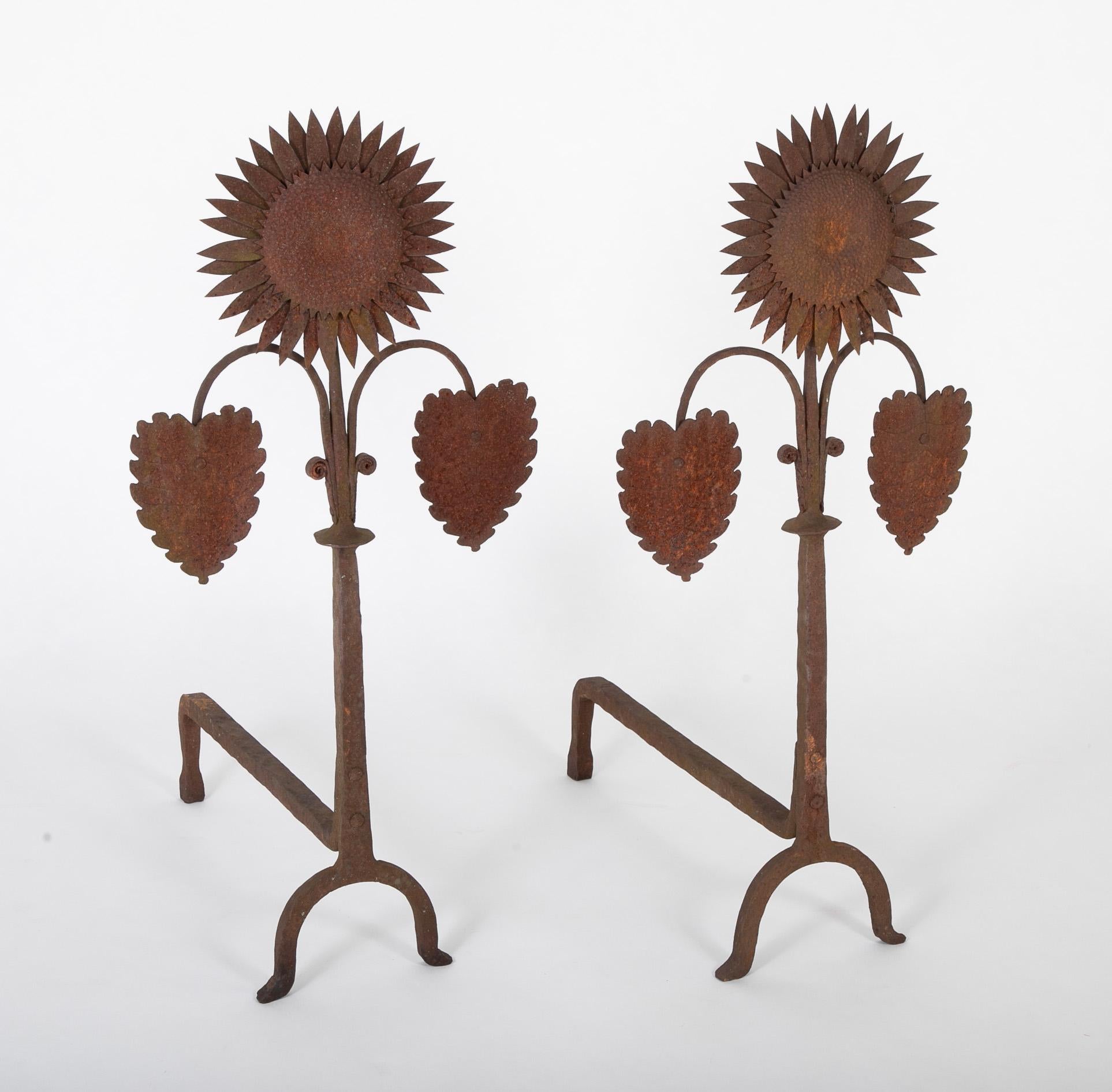 Handsome pair of sunflower form andirons in hammered tin and wrought iron believed to be English Arts & Crafts. 
 