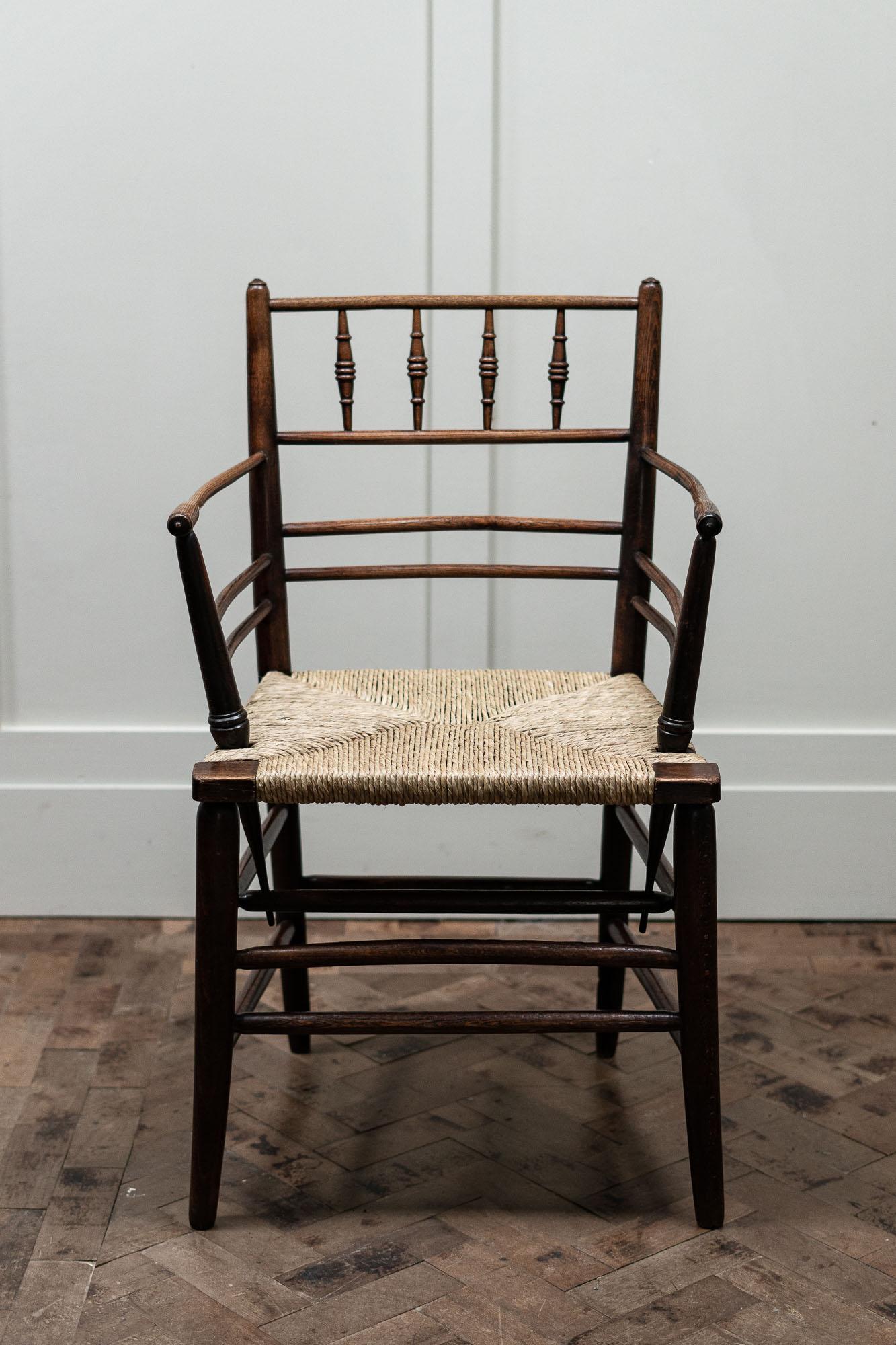 Arts and crafts Sussex chair, by Philip Webb for Morris and Co.

Made from beech and ash with a rush seat. The seat has been re-done in new rush. 

Measures: Height 84cm
Seat height 45cm
Width 52cm
Depth 44cm.