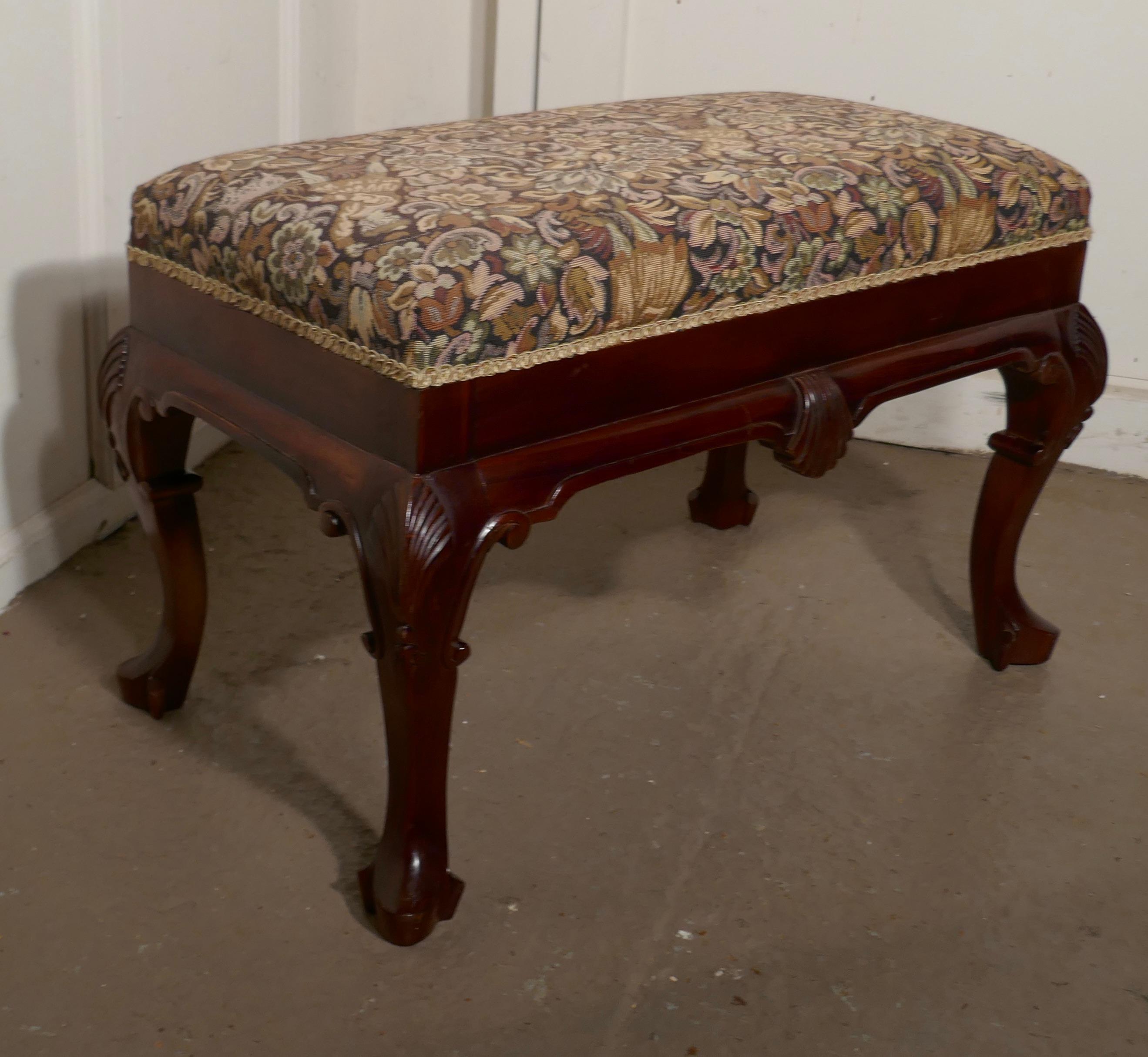 rts & Crafts tapestry upholstered mahogany stool

A lovely piece, made in red mahogany, it stands on decorative carved Cabriole legs and the deep seat is upholstered in a Arts & Crafts design hunting print fabric with faded black background
The