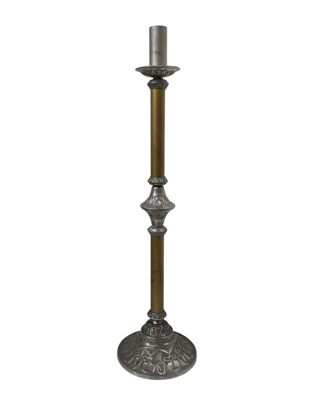The Arts and Crafts Two Tone Aluminum and Brass Art Deco Floor Standing Candelabra is a unique piece that combines elements from both the Arts and Crafts movement and the Art Deco style.

The Arts and Crafts movement, which emerged in the late 19th