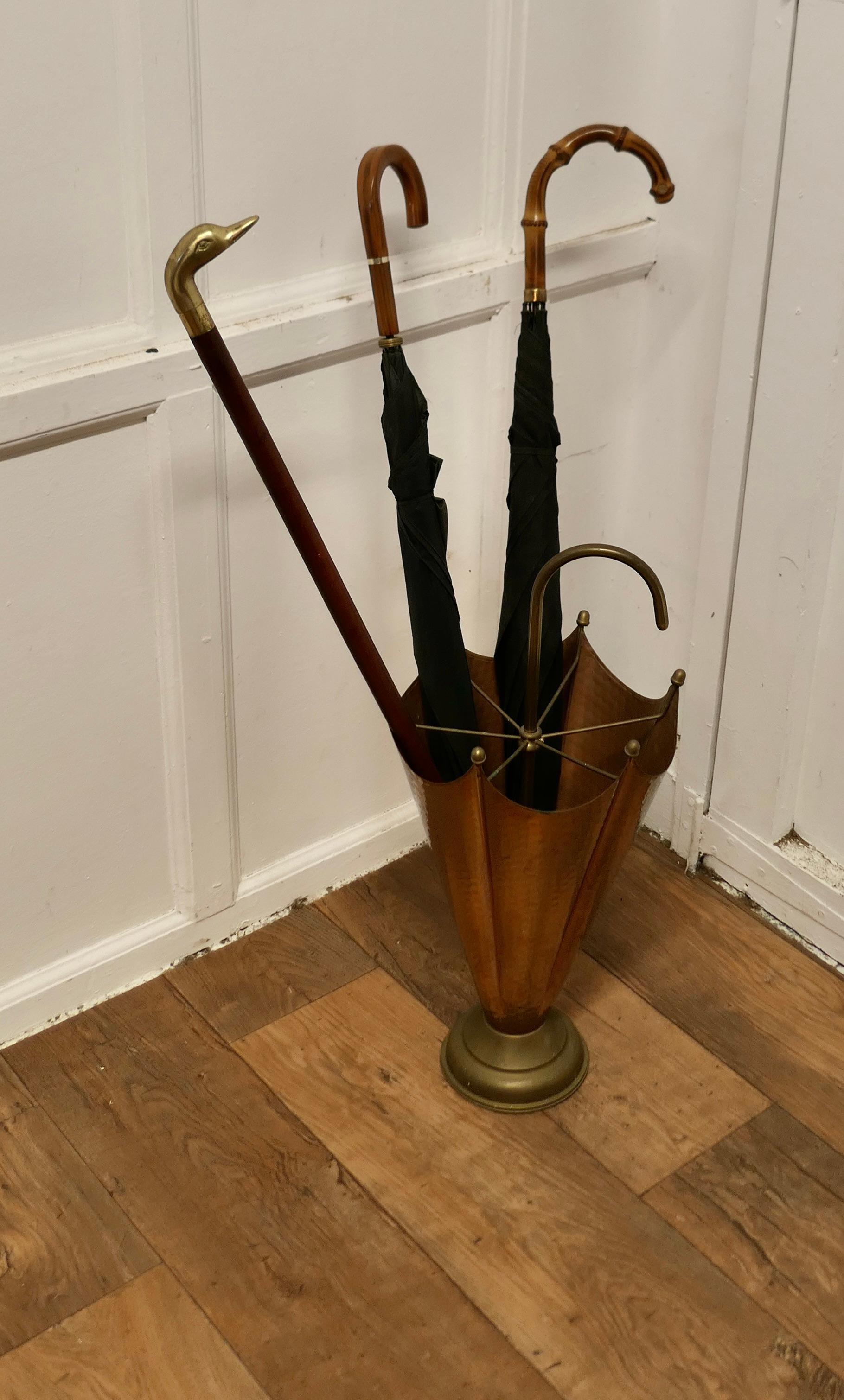 Arts and Crafts Umbrella Shaped Copper and Brass Umbrella Stand

An unusual and attractive piece, made in beaten copper and brass
The stand is divided into 6 sections and has an elegant hooped handle  
The stand is 26” tall and 12” in diameter 
TVY52