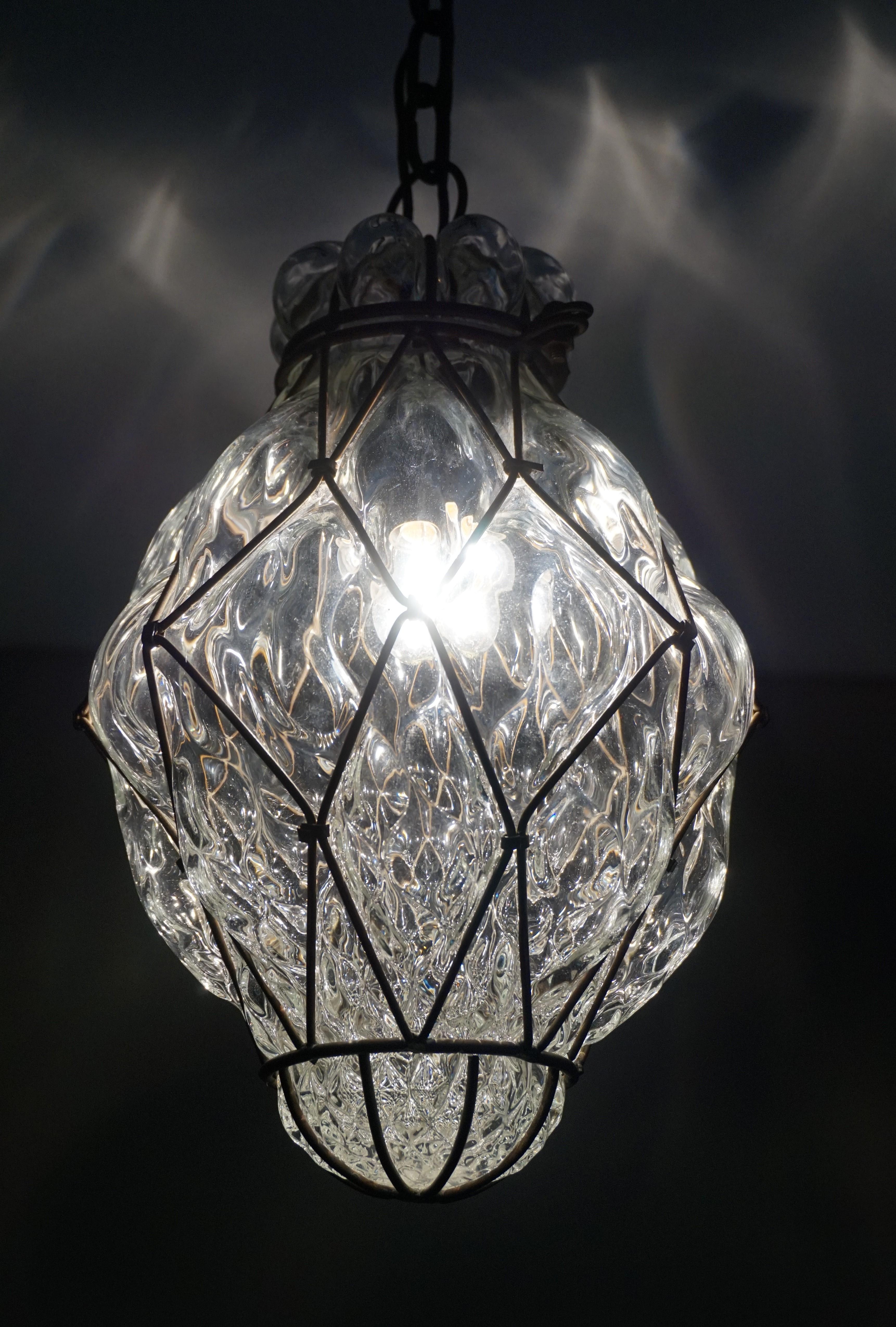 Stylish and excellent condition pendant from Venice.

This antique and rare light fixture from circa 1910-1920 is another one of our recent great finds. This Arts & Crafts design is unlike any handcrafted Venetian pendant that we have ever seen,