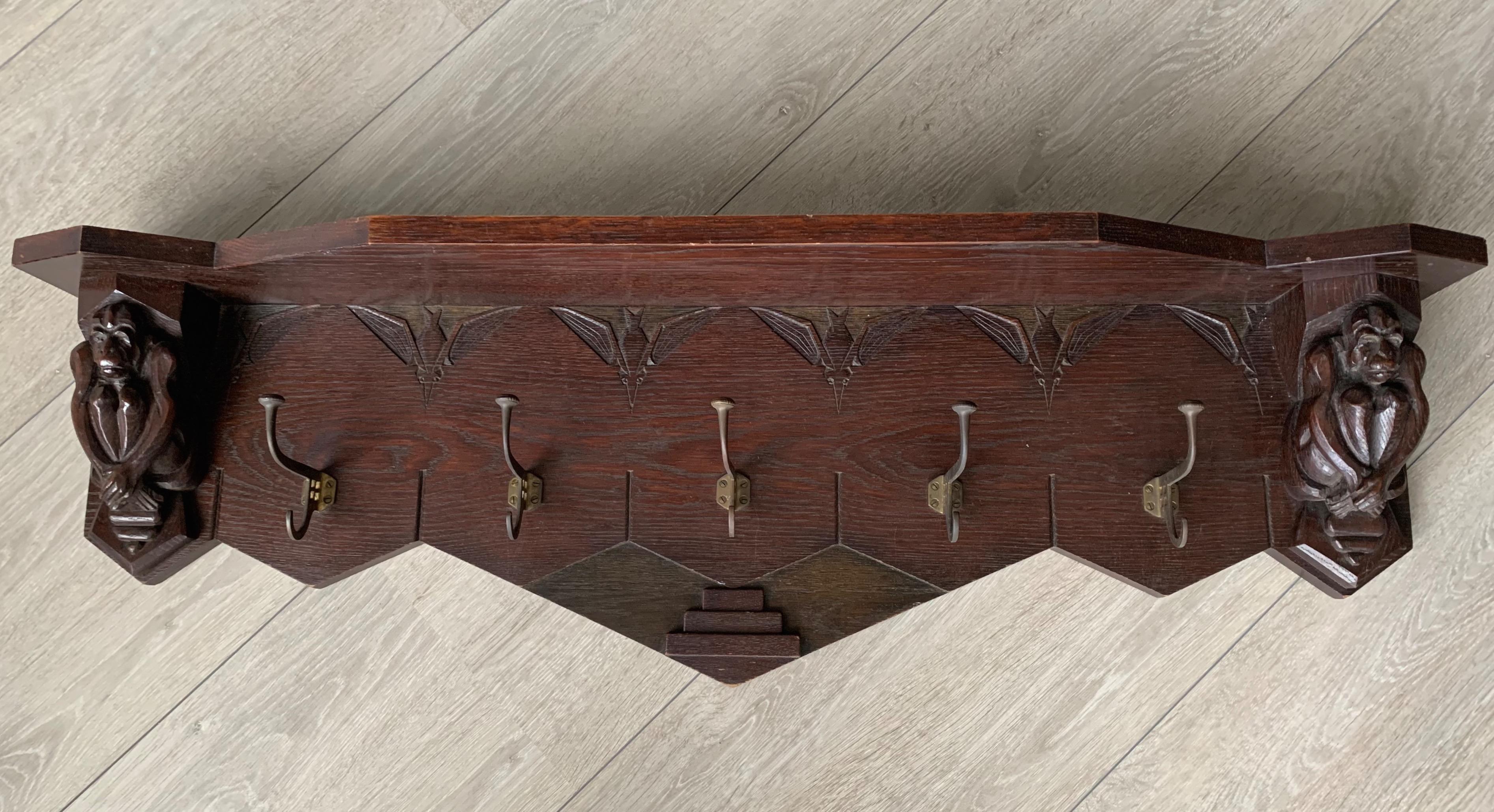 Stunning antique coat rack made of oak with stylish brass hooks.

If you are a collector of handcrafted, early 20th century decorative art then this striking, sculptural coat rack could be gracing your entrance soon. This rare and wonderful looking