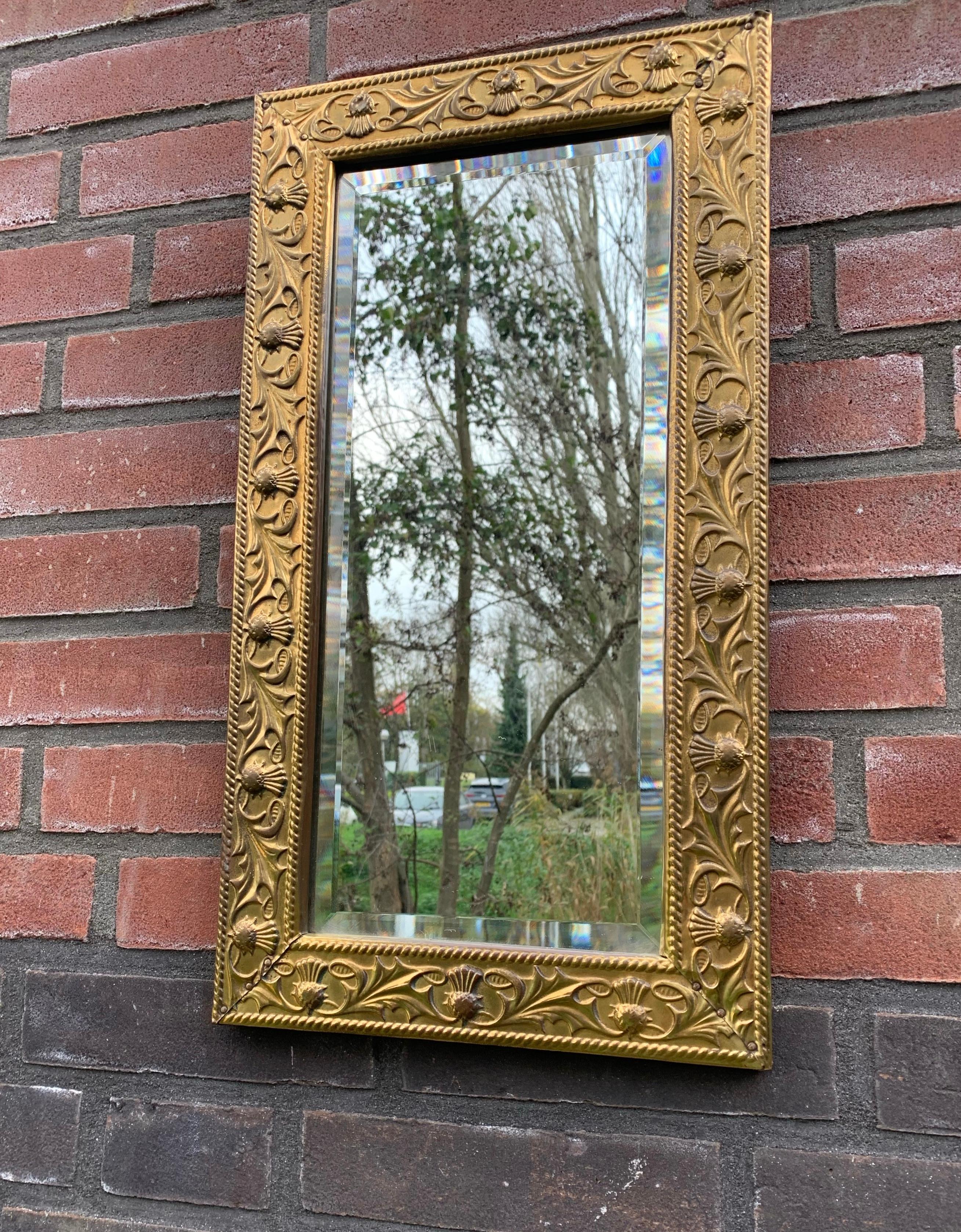 European Arts & Crafts Wall Mirror with Stylized and Embossed Brass Thistle Flowers Frame