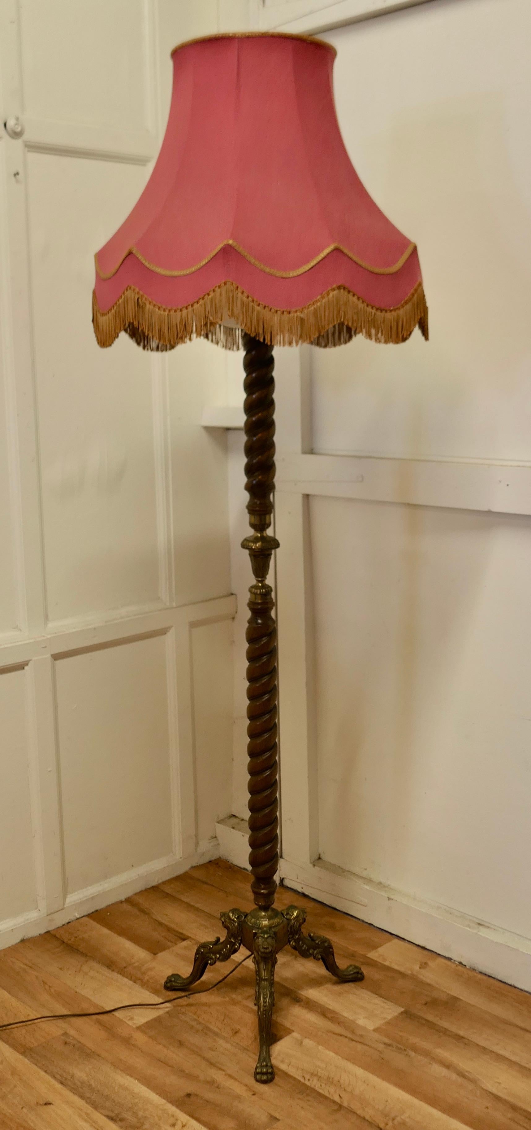 Arts and Crafts Walnut Barley Twist and brass floor standing lamp

A skilfully turned and very attractive piece of walnut forms the upright of the lamp, it is set on a 3 footed base in the form of 3 lions
The lamp is in good condition, the shade