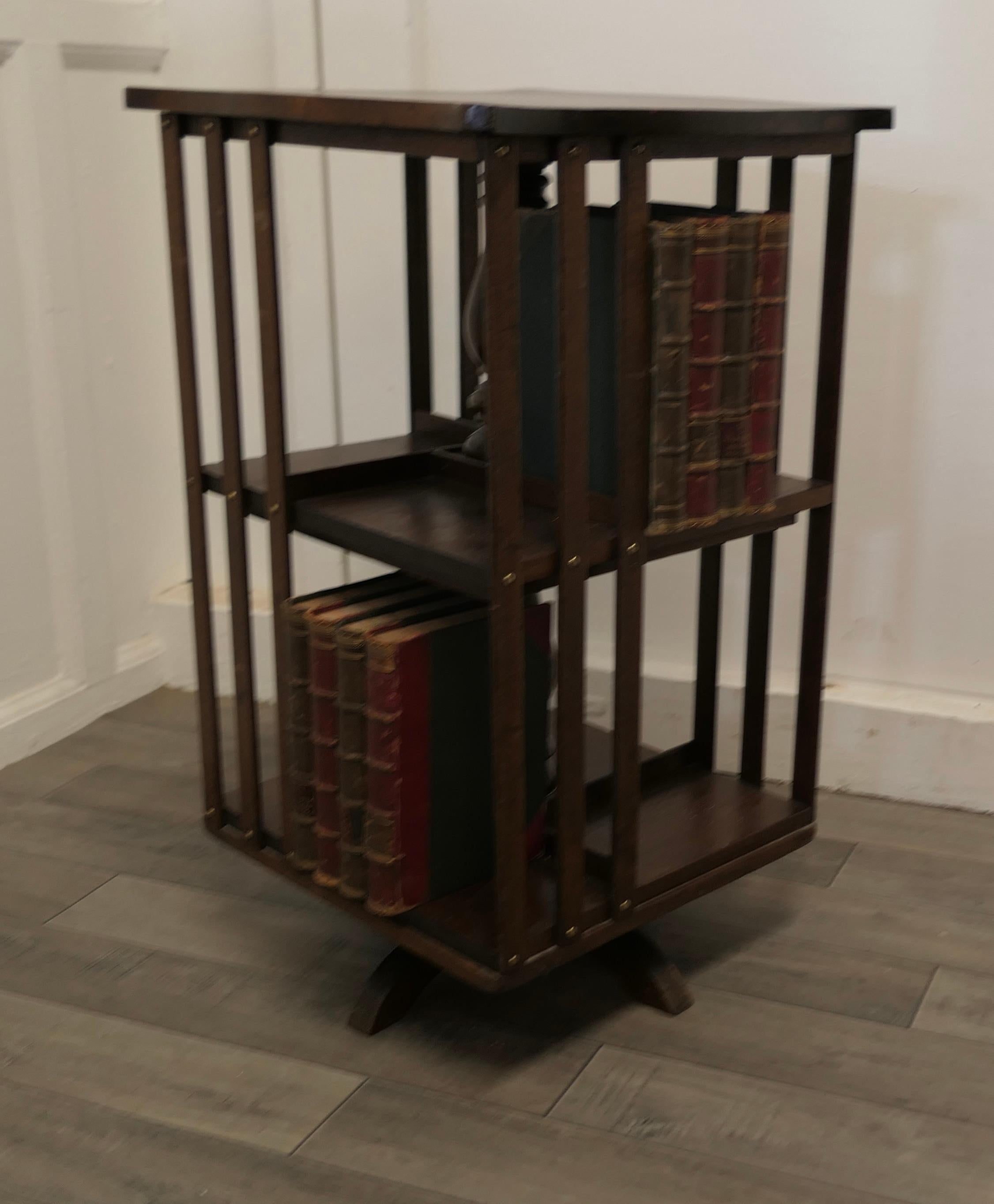 Arts and Crafts walnut lamp table bookcase

The Bookcase or Lamp table is a very handy piece, with book 2 shelf storage on all 4 sides
The bookcase is in good antique condition
The Bookcase is 15” square and 26” high
TJK85.