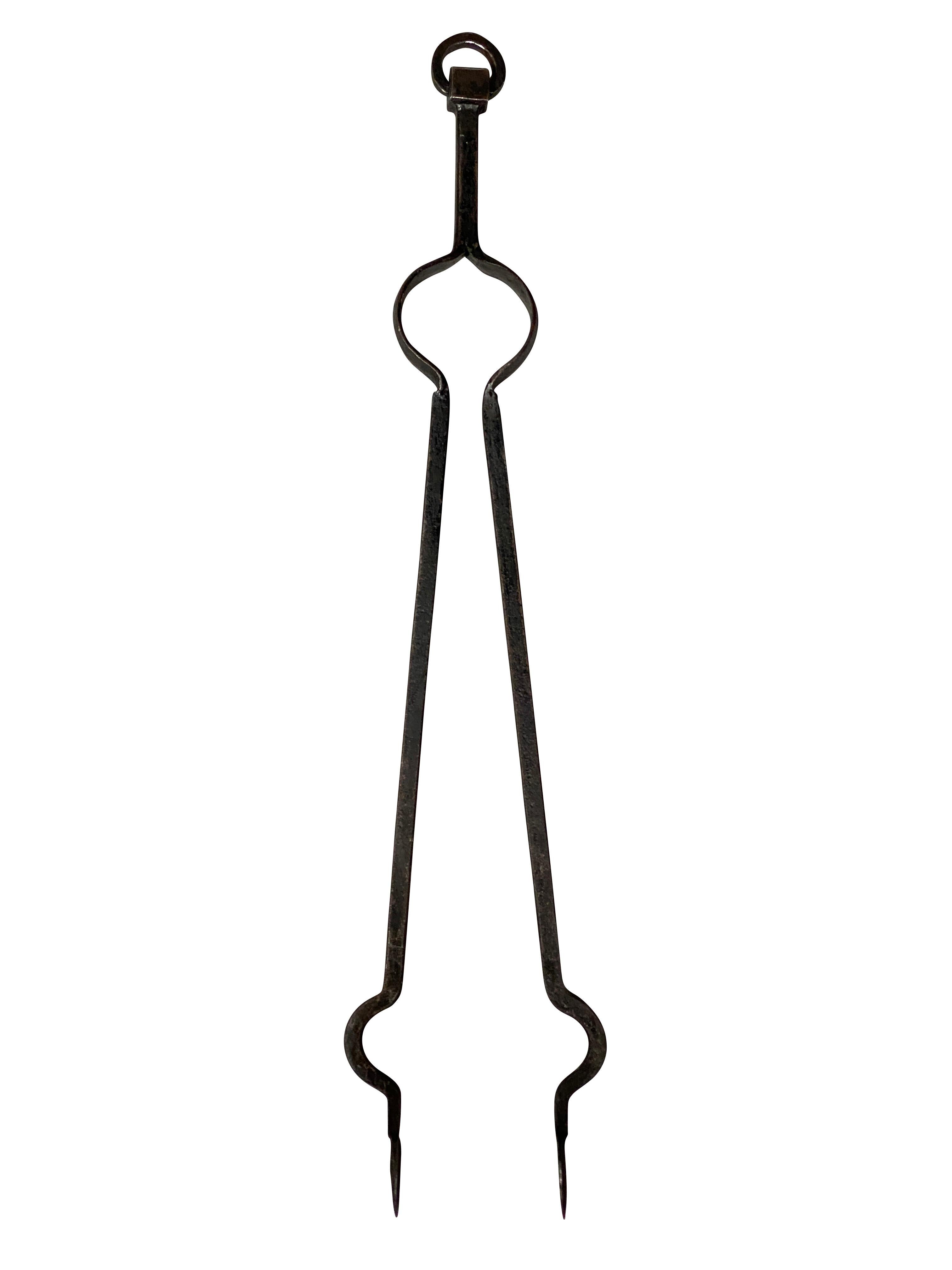 Comprising a poker, shovel and tongs. Heavy gauge with nice patina. Conforming stand with three legs and flat round feet.