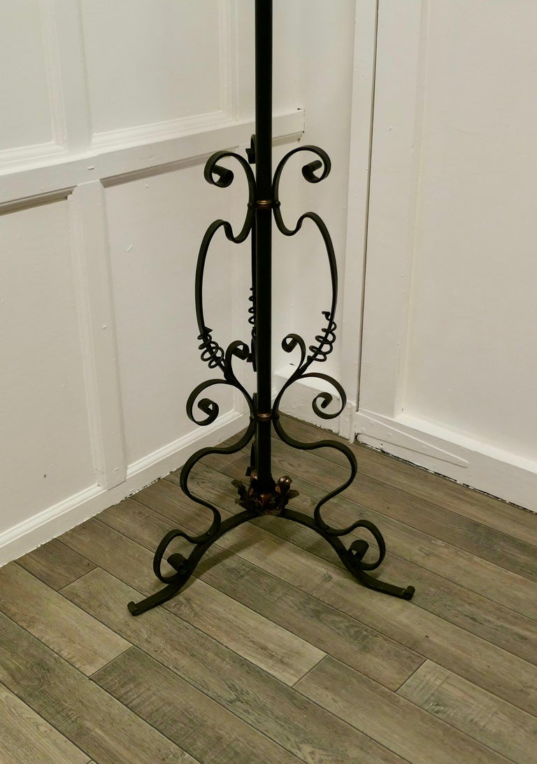 Arts and Crafts Wrought Iron Floor Standing Oil Lamp

This is a very attractive piece, the lamp has a decorative wrought iron base highlighted with Copper detail, it has a chimney and burner but I cannot guarantee if it is in working condition but