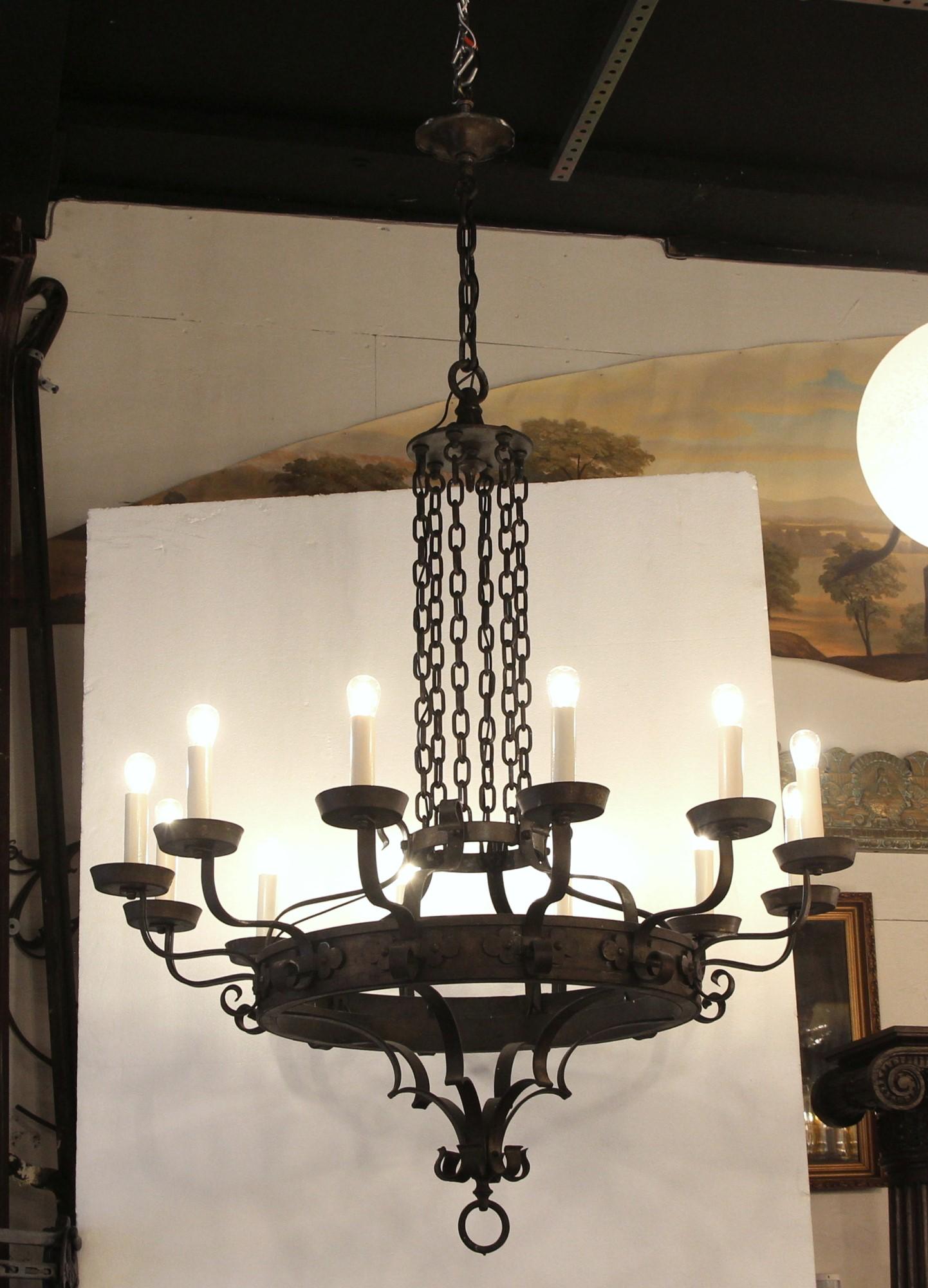 Early 20th century large scale Arts & Crafts chandelier with 12 arms. Done in wrought iron. Simple but beautiful scroll work. French wired. Cleaned and rewired. Please note, this item is located in one of our NYC locations.