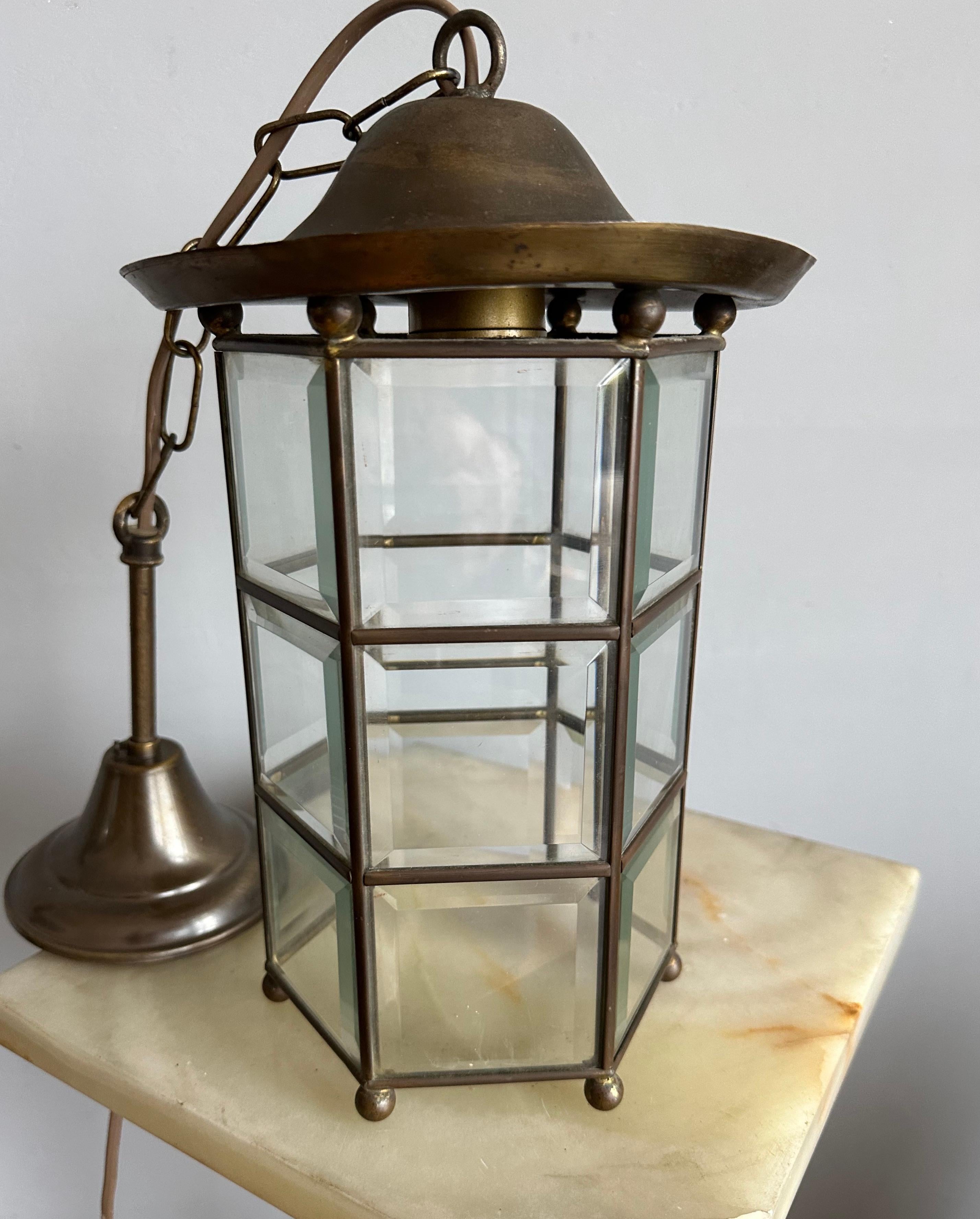 Small size and excellent condition, brass and beveled glass lantern.

This stylish and timeless design pendant is all handmade and in excellent condition. This hexagonal pendant has a total of  18 beveled glass 'window sections' framed in brass and