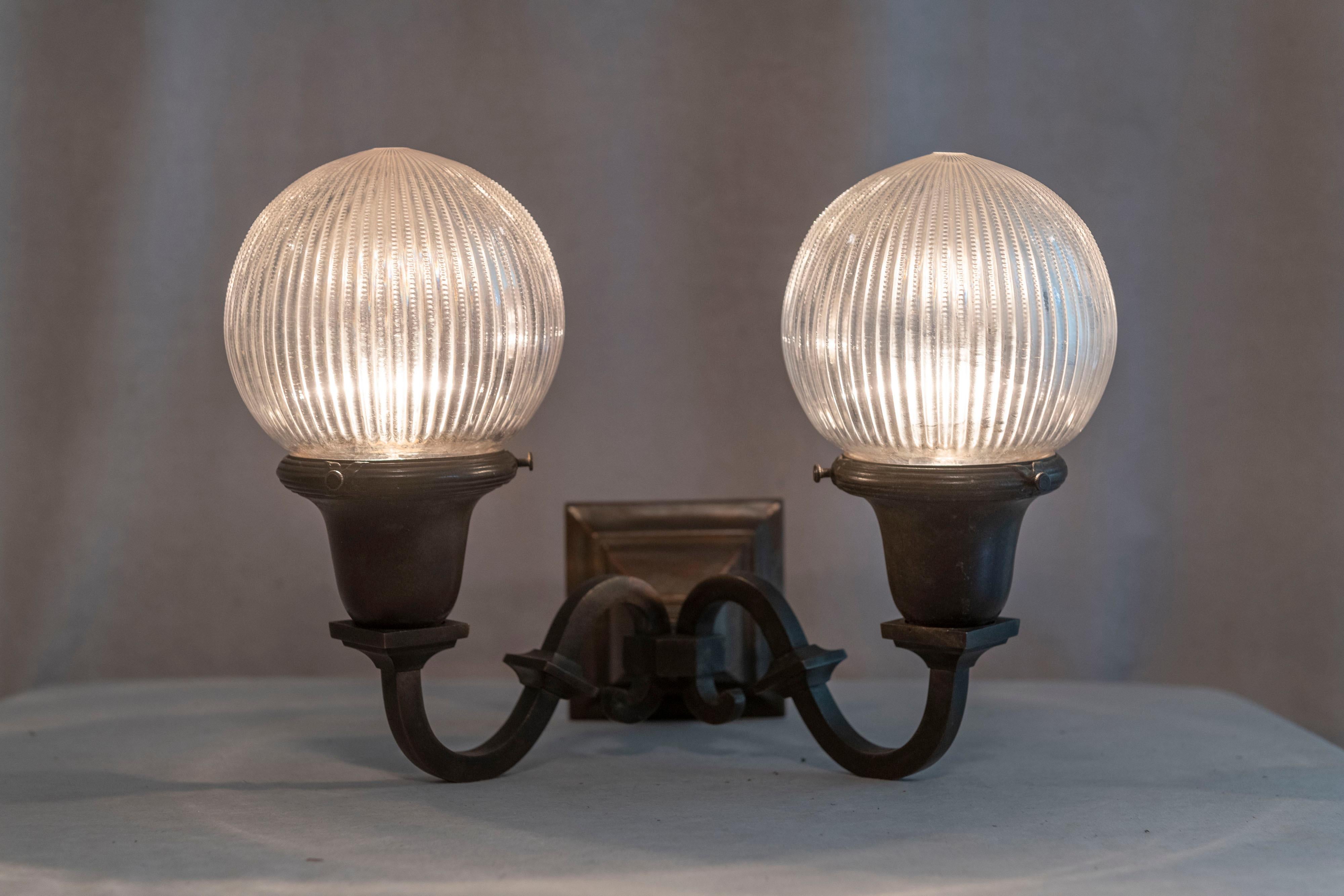  If you are looking for a single sconce in the arts & crafts style, this is a perfect choice. Clean, simple handsome metalwork highlighted with 2 rather rare and wonderful glass shades. While not signed, the shades are done in the style of the