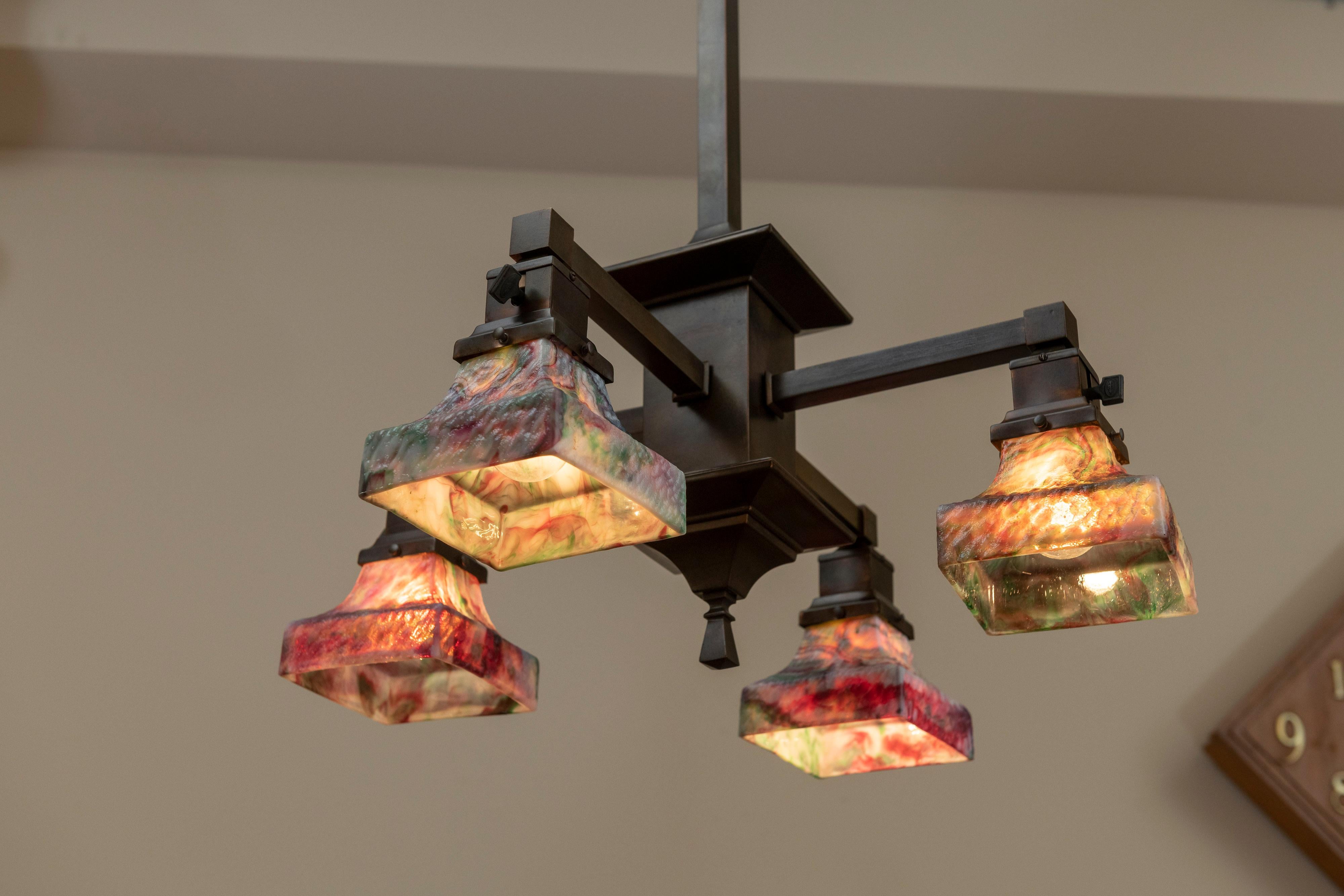 This chandelier is a total commitment to the Arts & Crafts movement. The shades are incredible with amazing color and texture. They were produced by the Kokomo Glass Co. from Indiana, which dates back to the 1880s.
This chandelier has been newly