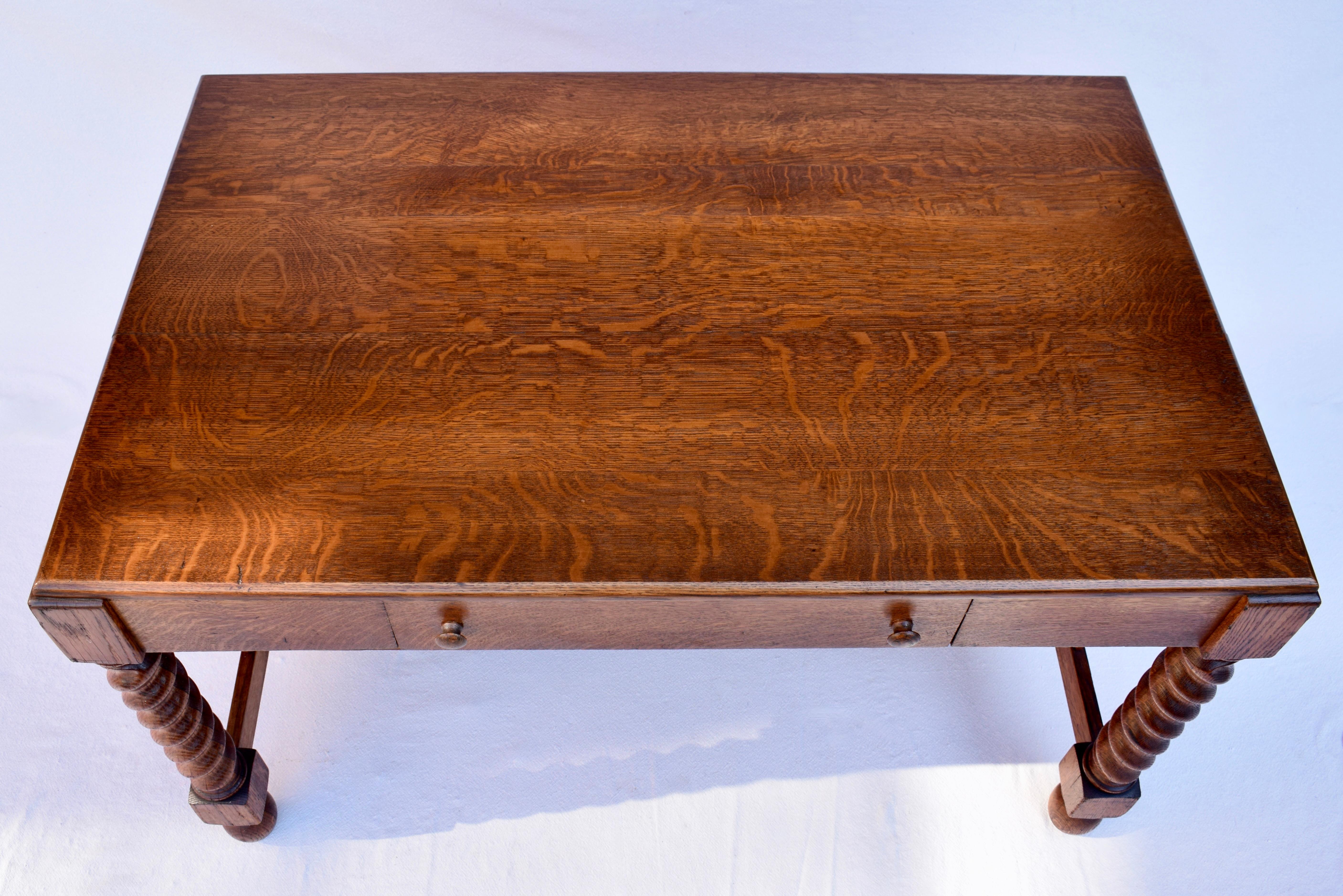 American antique Arts & Crafts solid quarter sawn Oak library table with original finish. Unusual in its distinct Mission & English influences. Boasts a single drawer with impressive barely twist legs. Circa early 20th century.  Tag remnant remains: