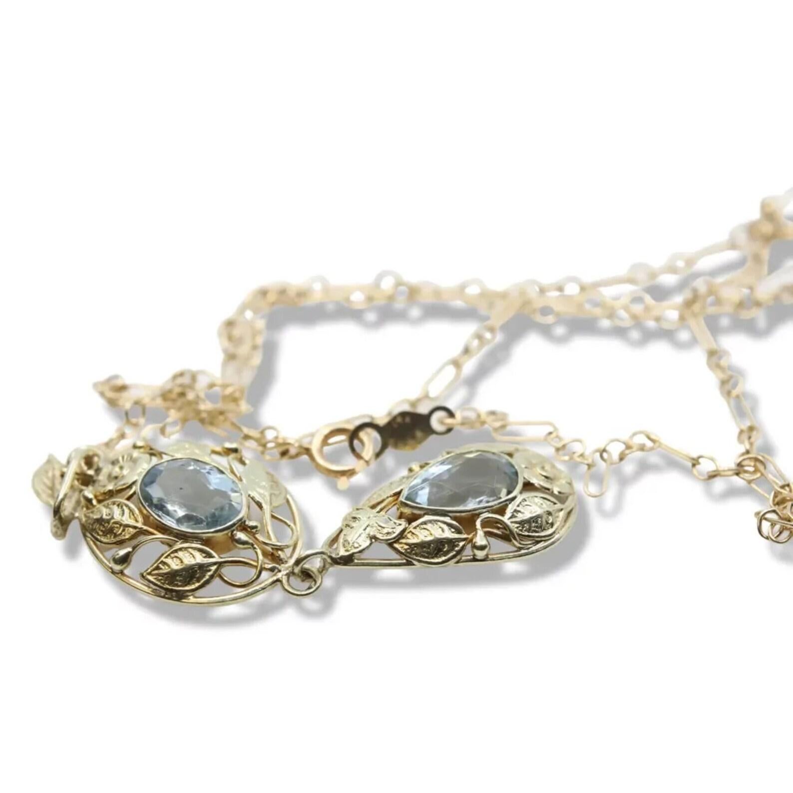 A hand crafted original arts and crafts period aquamarine and foliate decorated necklace in 14 karat yellow gold. Featuring a pear shaped and an oval rose cut aquamarine this necklace is set with 2.50 carats of aquamarine. Surrounding the aquamarine