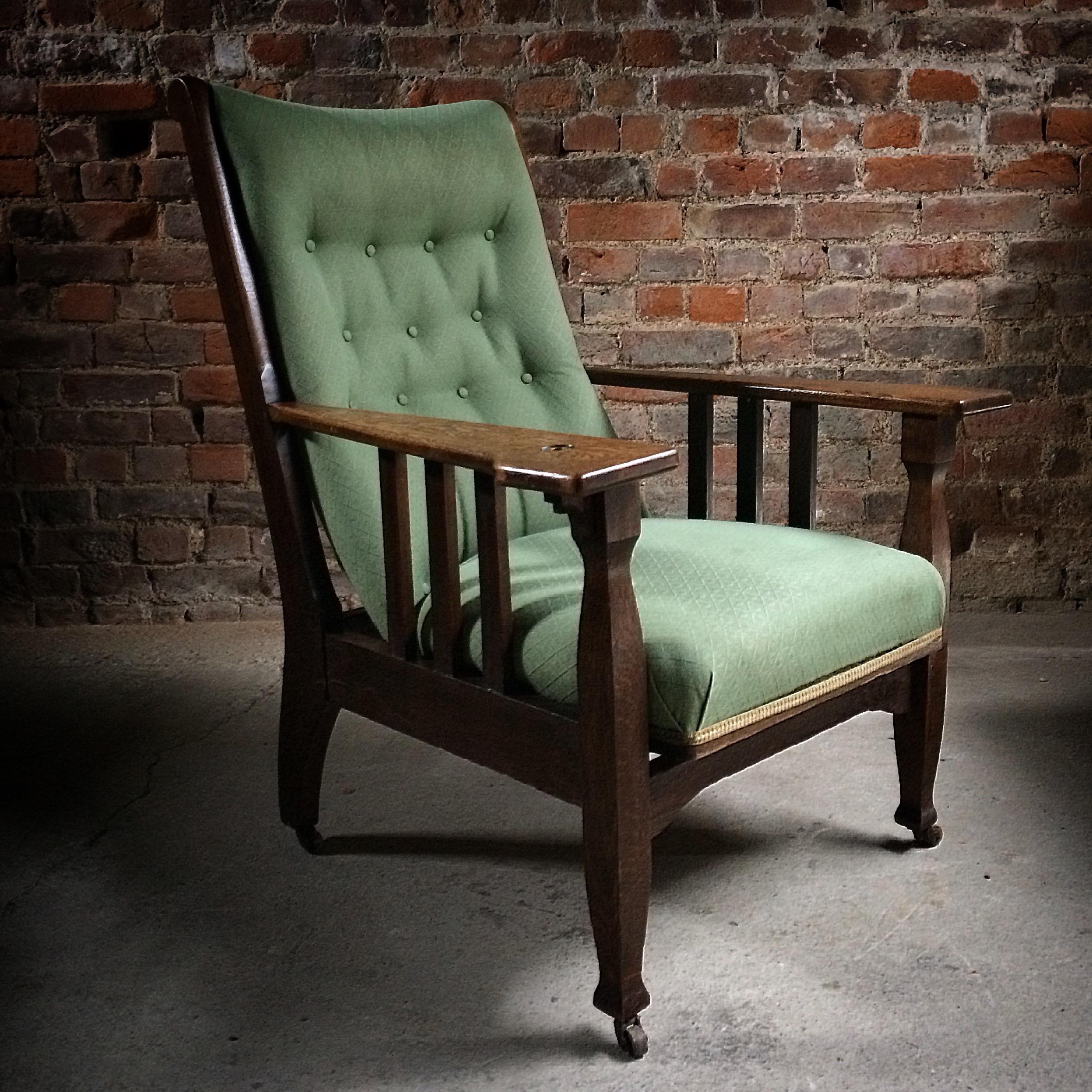 
A fabulous early 20th century Arts & Crafts oak button-back armchair or smokers chair circa 1920s, the green button back material is now tired and although still very useable it would benefit from being re-upholstered, the chair with adjustable