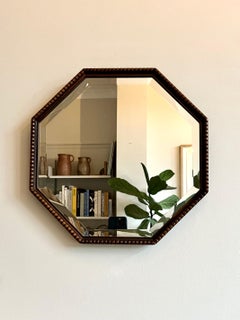 Arts & Crafts / Art Deco antique octagonal wall mirror with beaded wood frame.