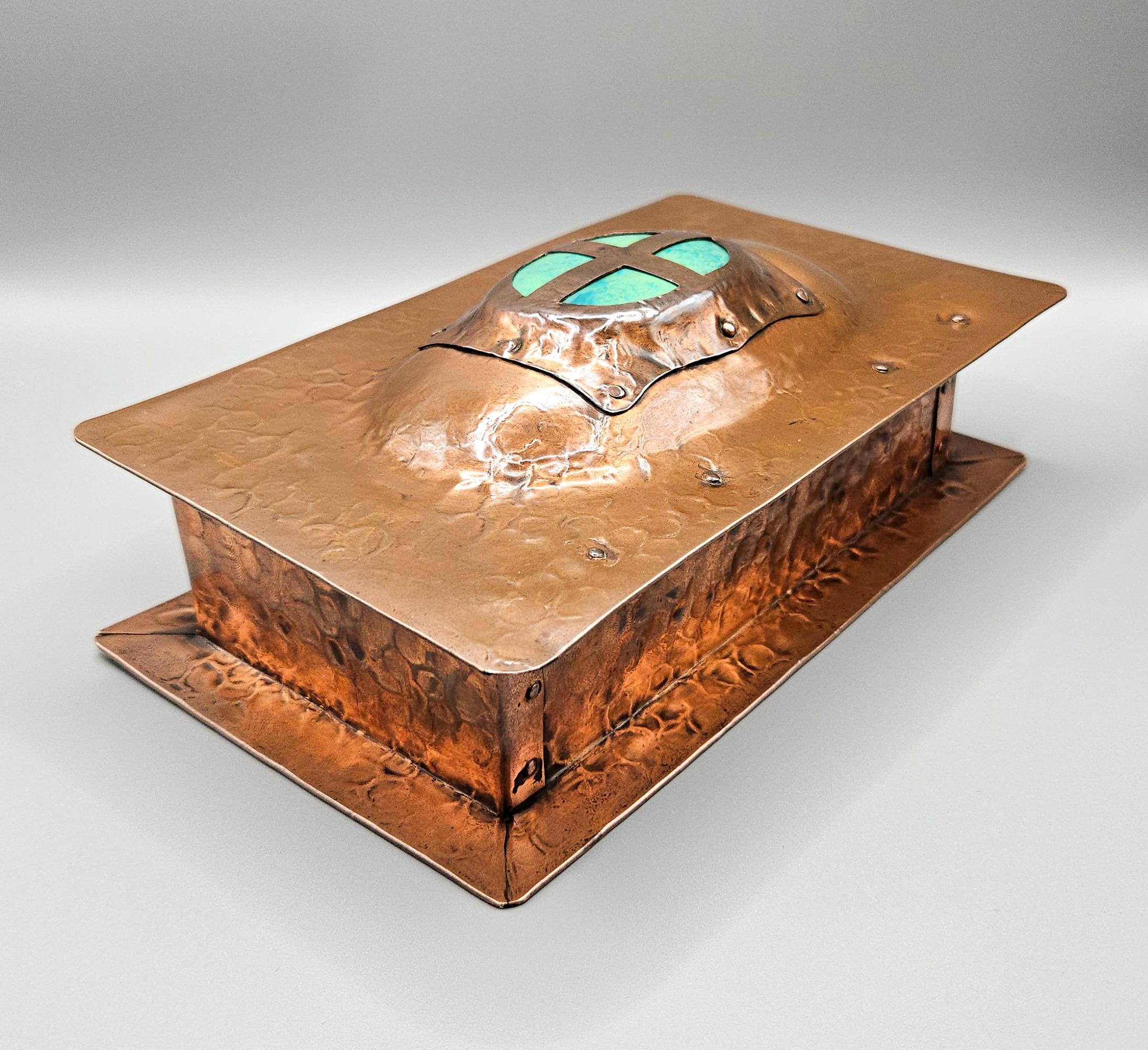 A wonderful Arts and Crafts hand-crafted copper and Ruskin enamel lidded casket. Made in England circa 1905 and attributed to A E Jones of Birmingham, this very decorative box was most probably retailed by Liberty's in London in the early 20th