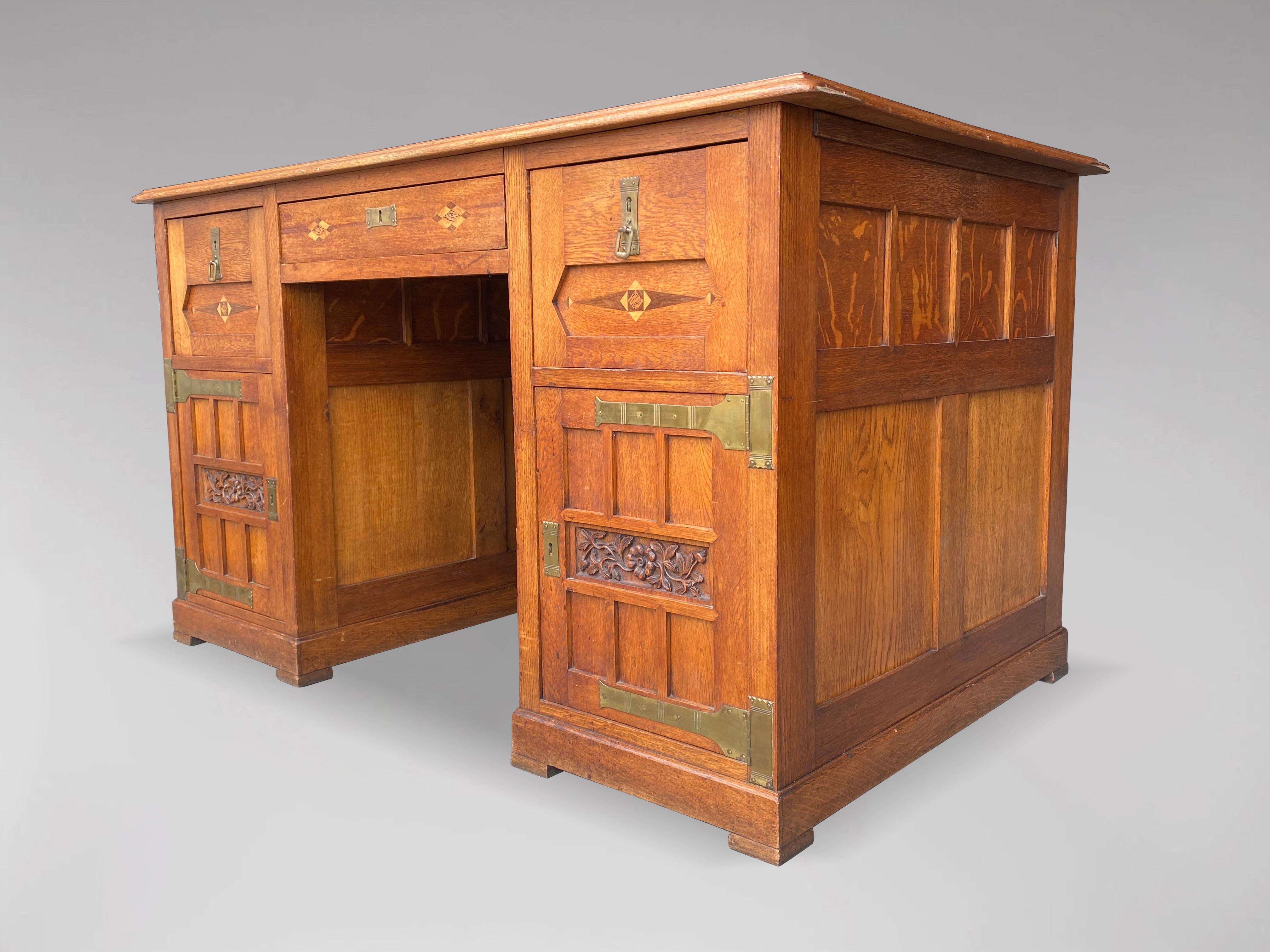 A magnificent and rare oak Arts & Crafts, Art Nouveau pedestal partners desk or bureau, in the style of Gustave SERRURIER BOVY (1858-1910). Solid oak, with original well shaped brass hinges, rosewood and satinwood inlays comprising cupboards and
