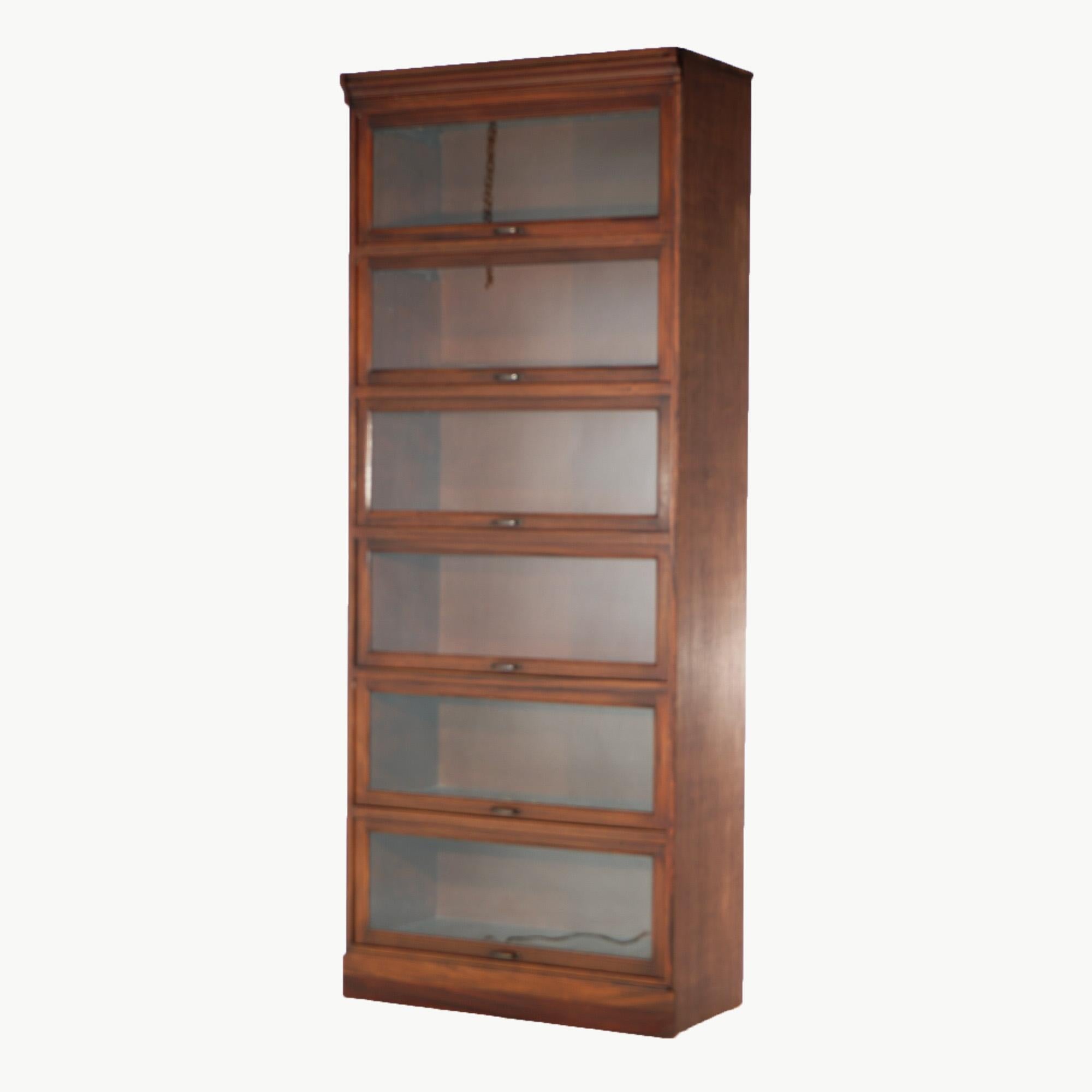 An Arts & Crafts Barrister style single unit bookcase offers mahogany construction with six sections, each having pull-out glass doors, 20th century

Measures - 90