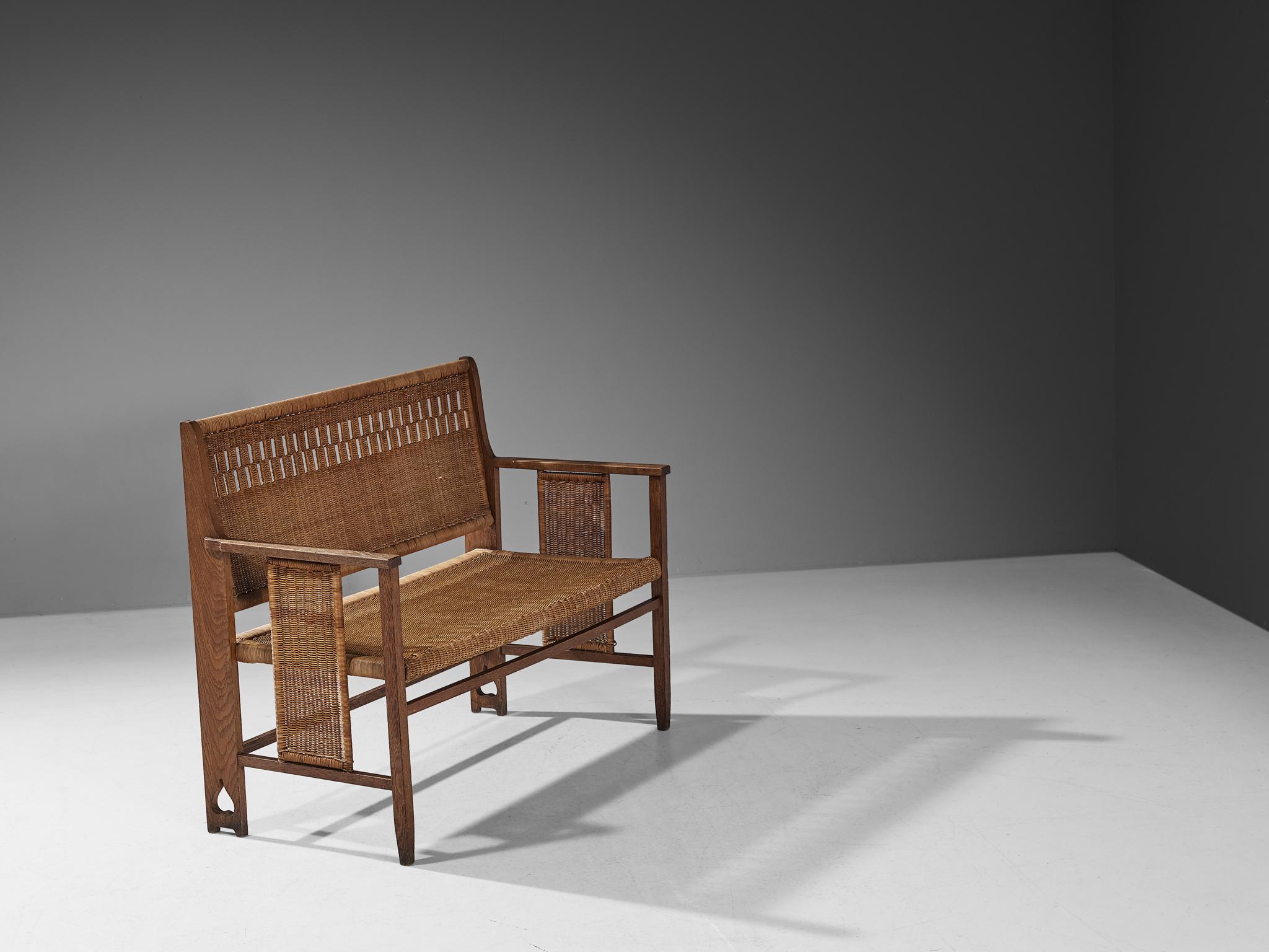 Bench, oak, cane, Austria, 1920s

This eloquent bench is designed during the Arts & Crafts period in Germany/Austria approximately around the twenties and designed by an experienced craftsmen whose identity is unfortunately not yet known. The