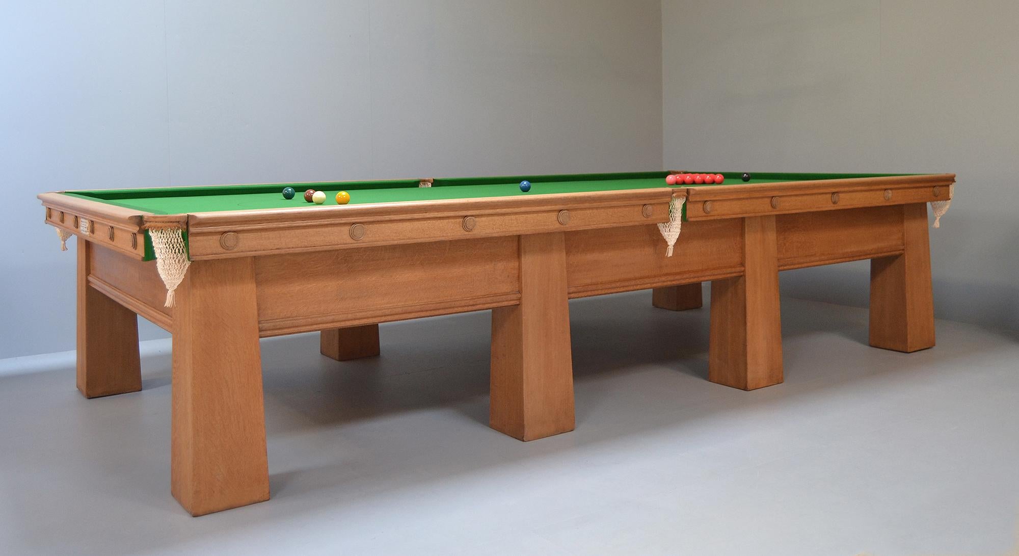 A wonderful Arts & Crafts billiard or snooker table in solid oak by Burroughes & Watts of London, this beautiful table has great presence.

Standing on eight gargantuan tapering legs, all of the frame fixings are internal so the line of the leg is