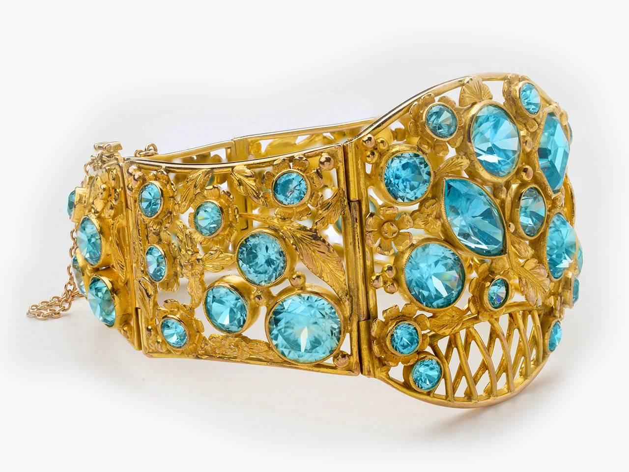 10k gold gold bracelet set with fancy and circular- cut  blue zircons ,designed as a flower basket with hinged panels.