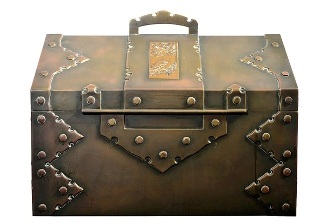 A late 19th century Arts & Crafts brass chest with a wood lined interior.
The hinged lid with a decorative brass carrying handle, brass riveted seams and applied brass plaques depicting Art Nouveau figures.