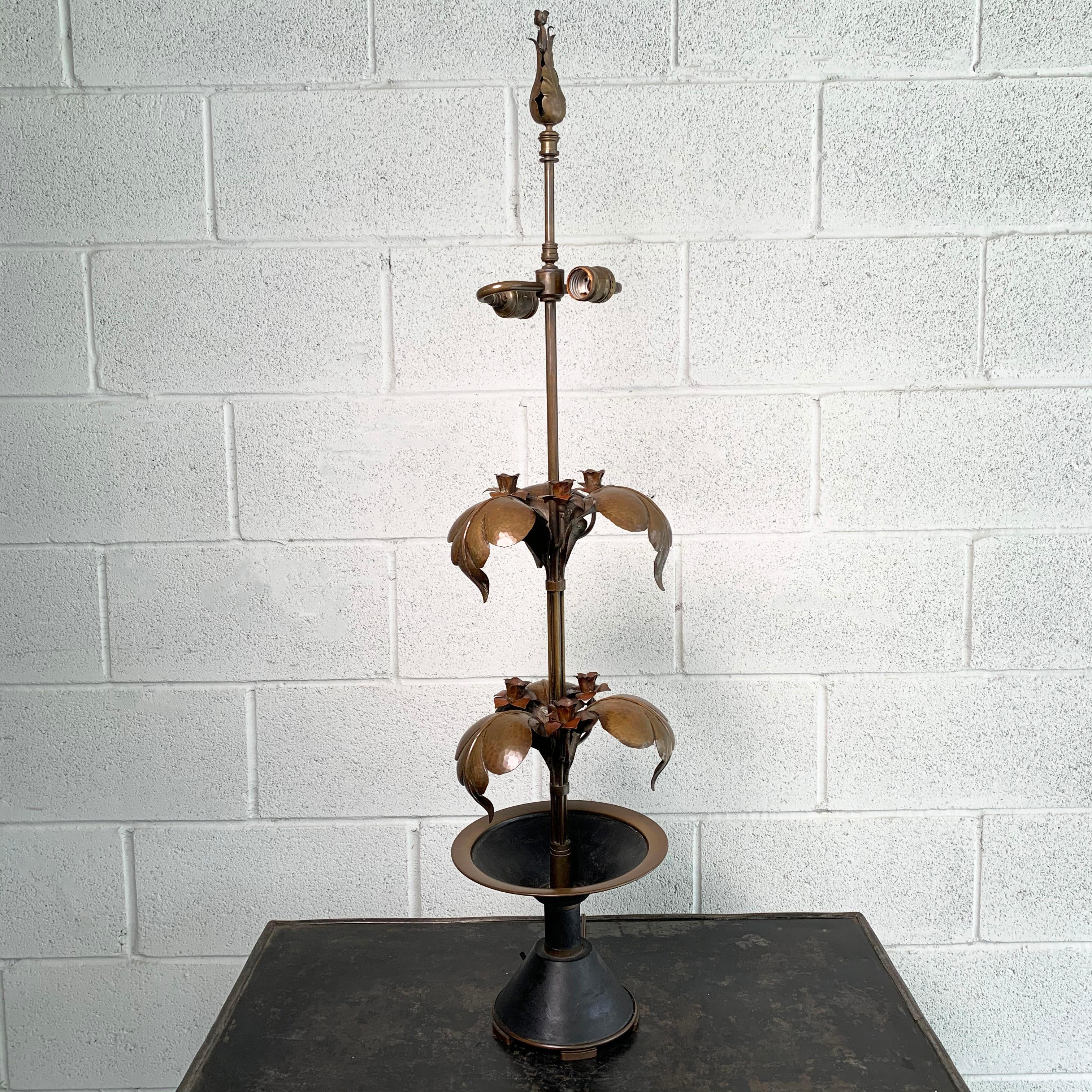 Elegant, brass, Arts & Crafts table lamp features a stem base with tiered leaves and planted rose buds with bud finial. The lamp is wired to accept two 75 watt max bulbs.