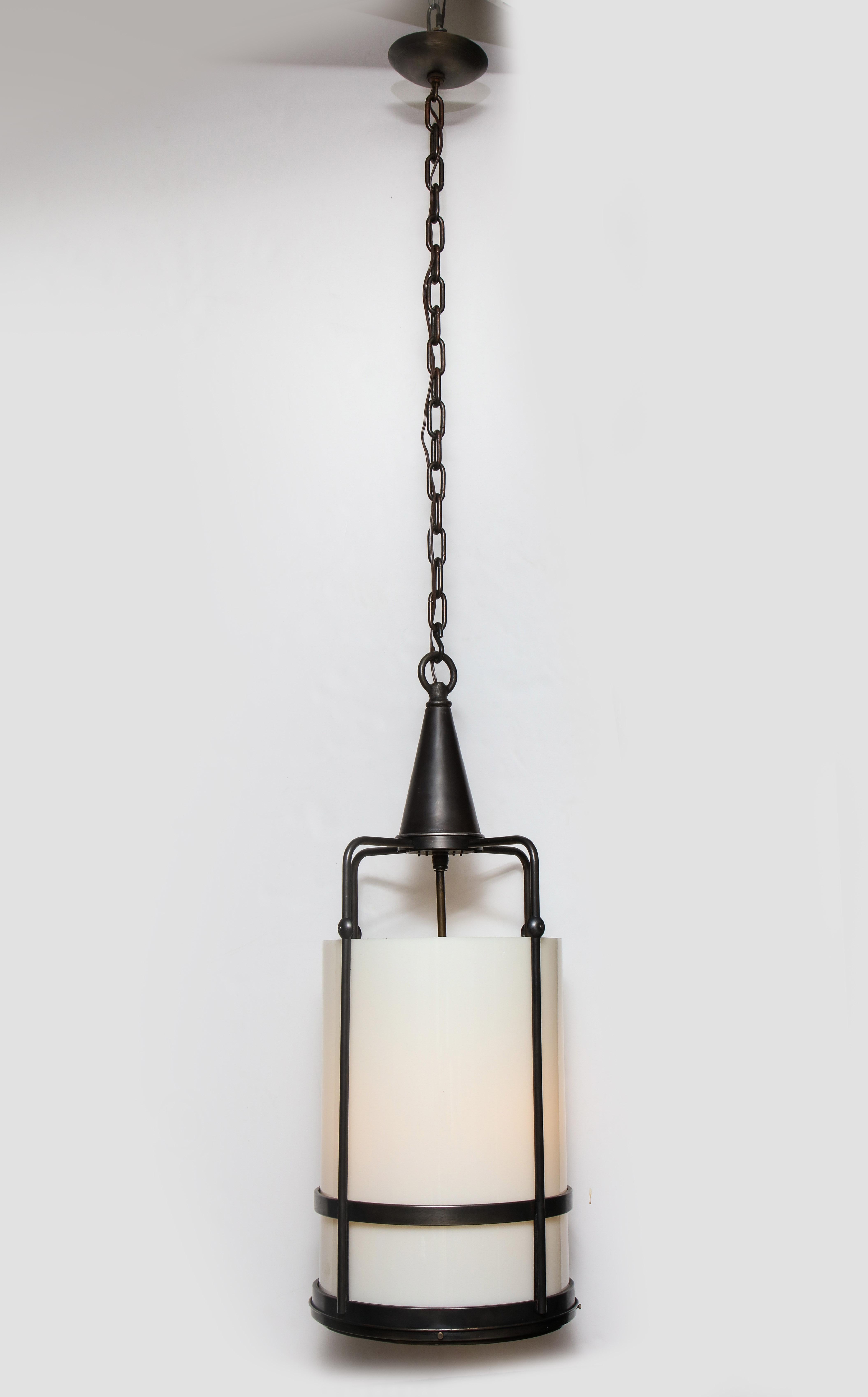 Arts & Crafts style heavy aged bronze frame lantern pendant with a thick white milk glass diffuser. Lantern houses 4-light sources which use Edison type bulbs. Rewired for use in the USA. Lantern body measures 37