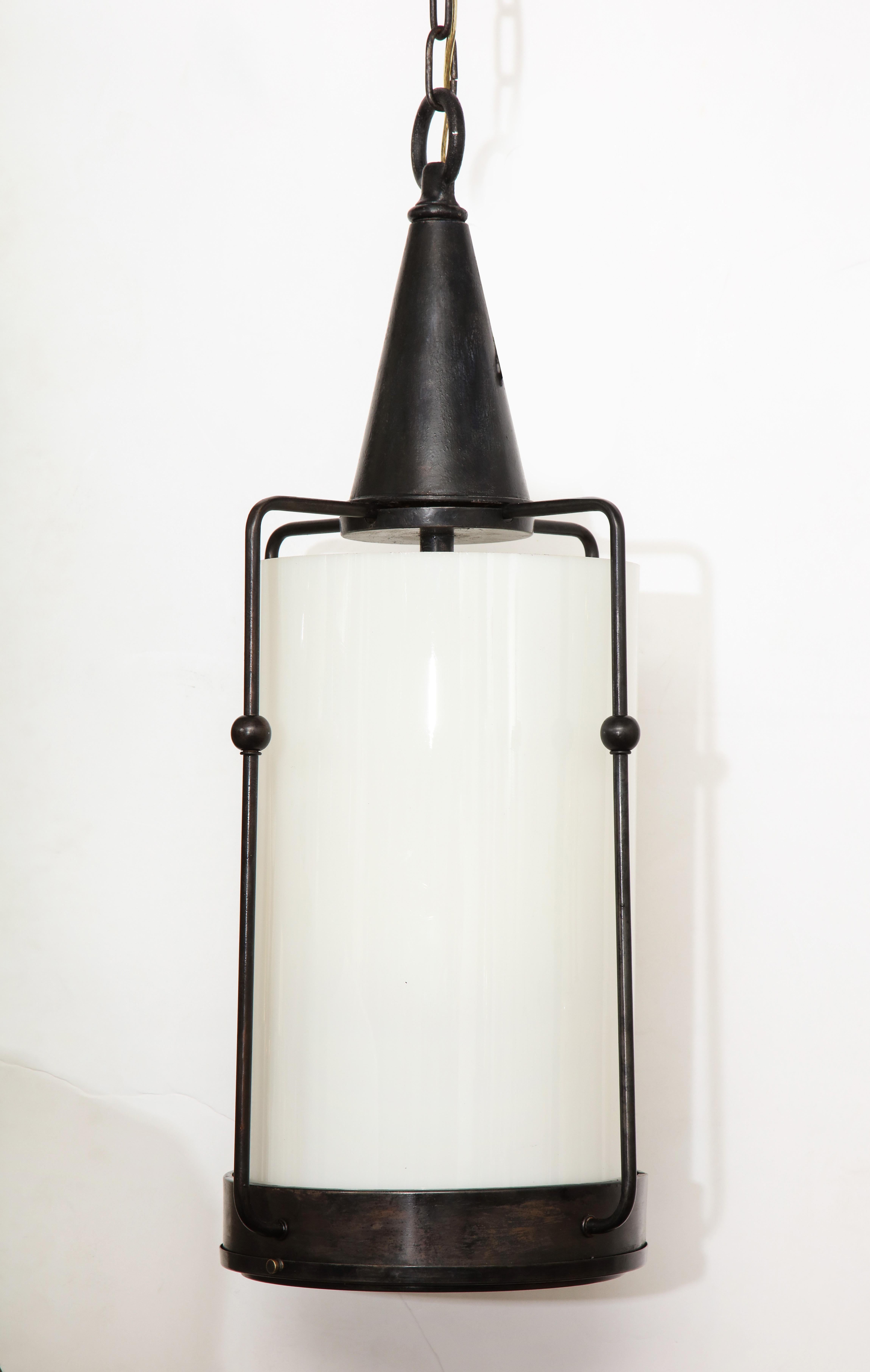 Arts & Crafts bronze lantern with thick white milk glass diffuser. Rewired for use in the USA, uses 4 candelabra type bulbs.

Measures: Length with chain is 57 inches.