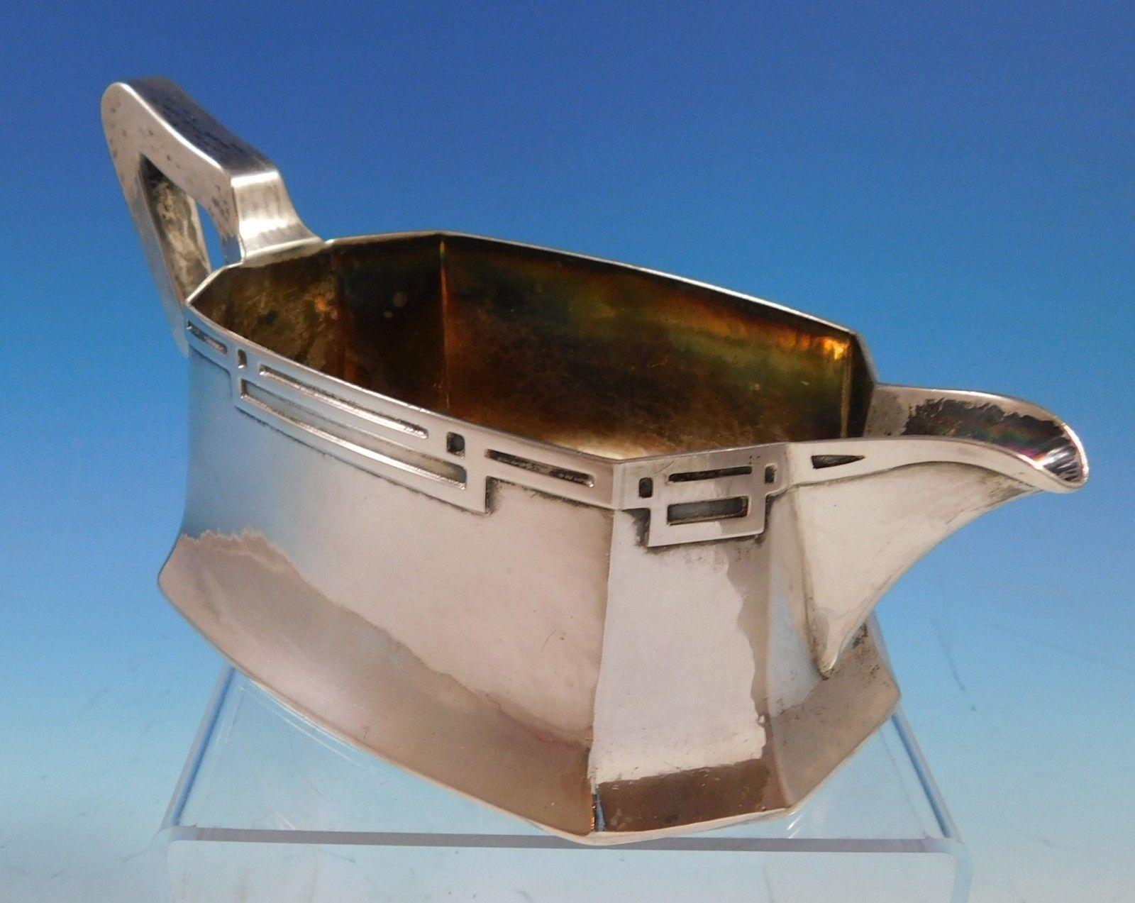 Arts & Crafts by Hallmark of NY
Arts & Crafts sterling silver gravy boat made by Hallmark of New York, circa 1900-1954. The gravy boat is handwrought with applied strapwork. The piece measures 3 1/2 x 8 3/4 x 4 1/4, and it weighs 9.98 ozt. It is