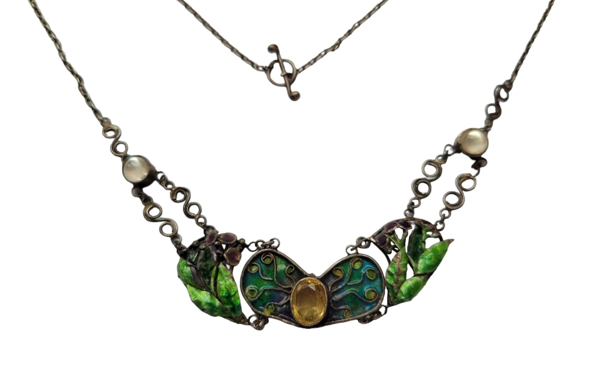A Beautiful Arts & Crafts c.1900s Silver, Enamel, Citrine and Moonstone necklace on original chain. Necklace made in traditional Arts & Crafts style. Fully hand crafted. Rare to find! English origin.
Width 16mm.
Length of the chain including clasp