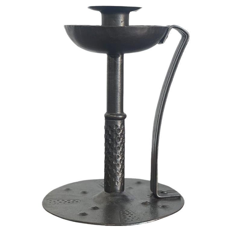 Arts & Crafts / Jugendstil candlestick signed Goberg a German secession Hugo Berger in wrought iron circa 1900. This candlestick has a pretty patina and a shape entirely characteristic of the German - Austrian secession. The circular base and the