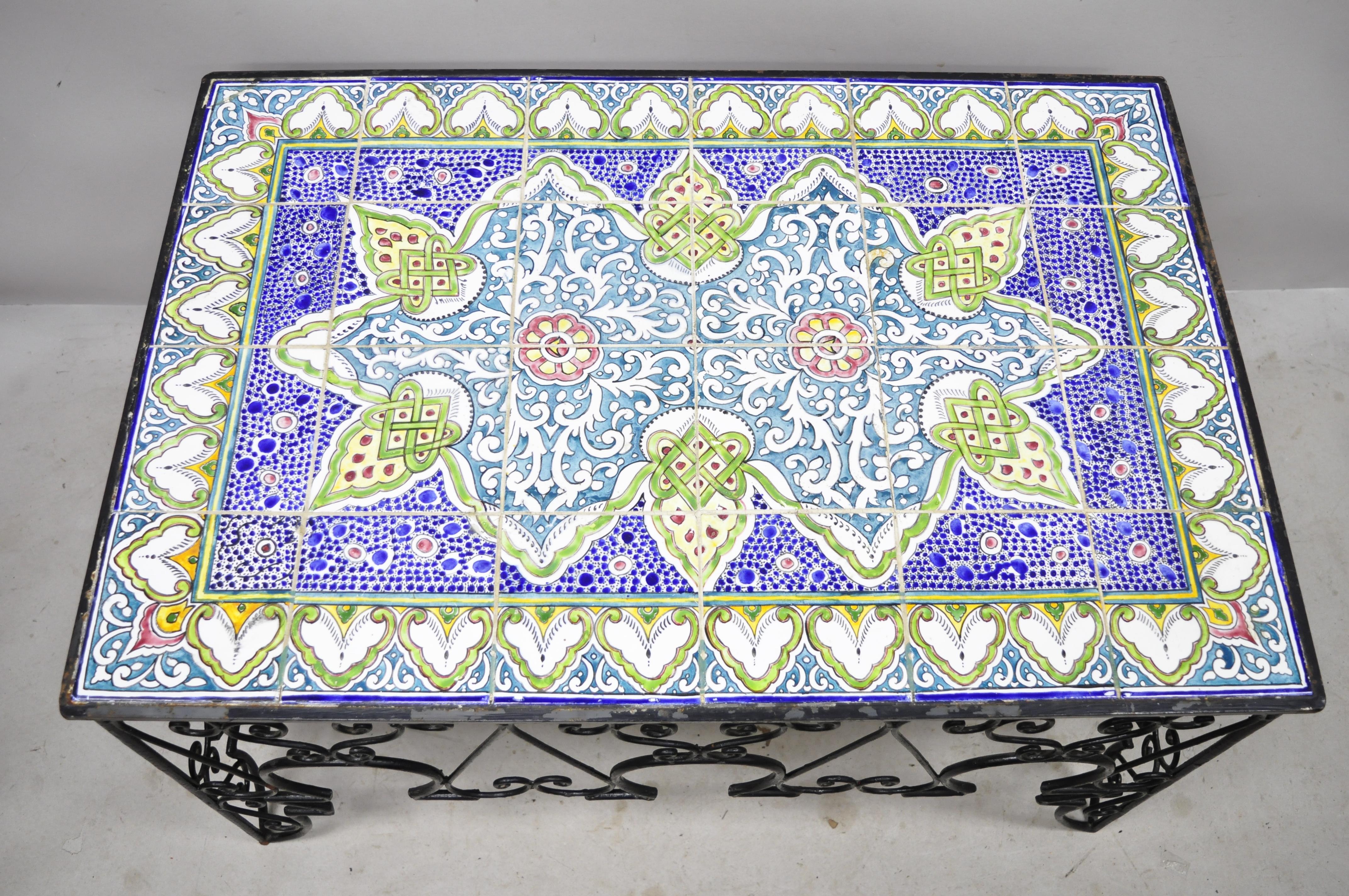 Antique Arts & Crafts ceramic California tile wrought iron coffee table attributed to Catalina. Item features (24) tiles, ornate wrought iron scrollwork base, stunning blue and green colors, very nice antique item, great style and form. Possibly by
