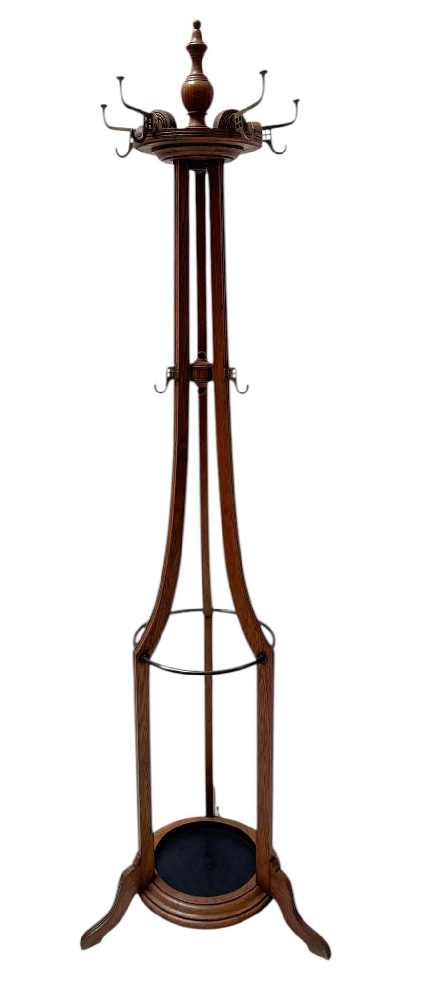 Magnificent and rare Arts & Crafts coat stand or porte manteau.
Striking Dutch design from the 1900s.
Solid oak frame with original rotating top.
Seven original Arts & Crafts patinated brass hooks.
With integrated brass rings and drip section for