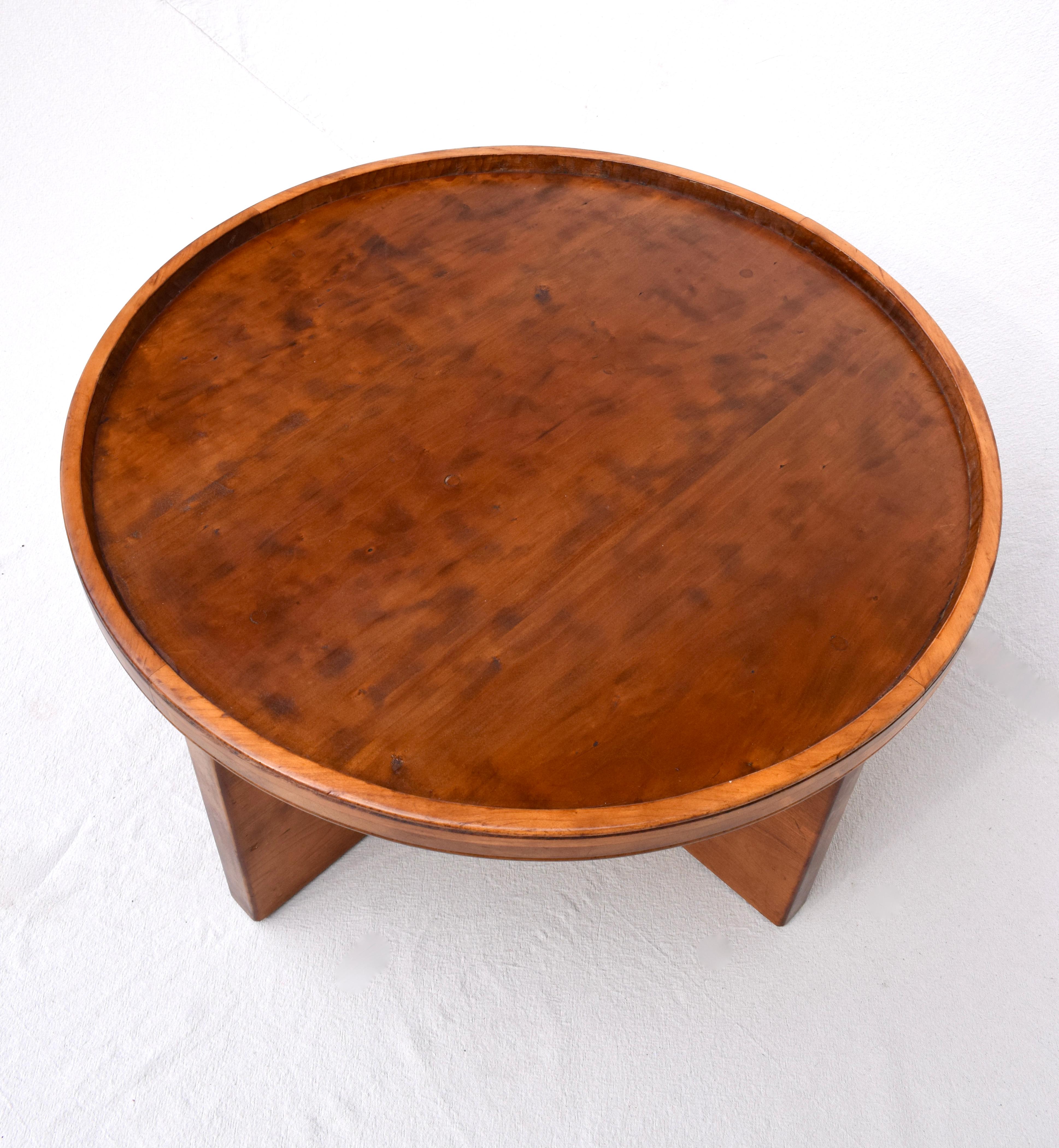 A solid wood cocktail or coffee table in the manner of Frank Lloyd Wright Taliesin for Henredon designs. A studio piece, the table is beautifully hand crafted and chiseled on the inside radius of the top. Especially substantial suitable for use as a