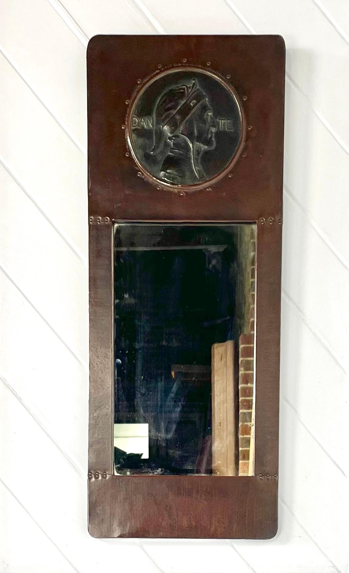 Arts & Crafts copper framed mirror
with an inset cast bronze roundel depicting 