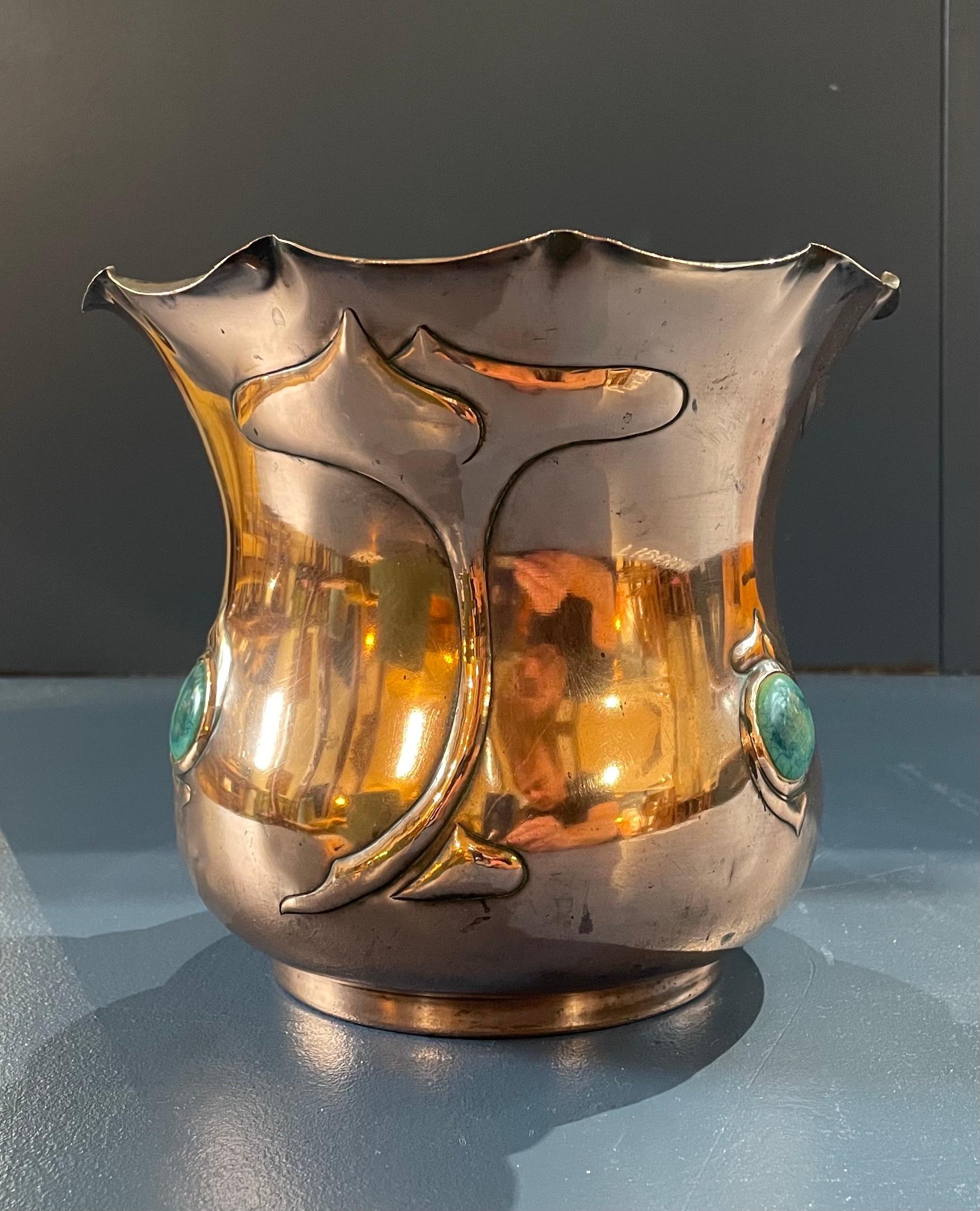 Arts & Crafts copper jardiniere 

Inset with 4 inset Ruskin blue pottery roundels 

Fluted top and stylised plant form decoration 

Circa 1900