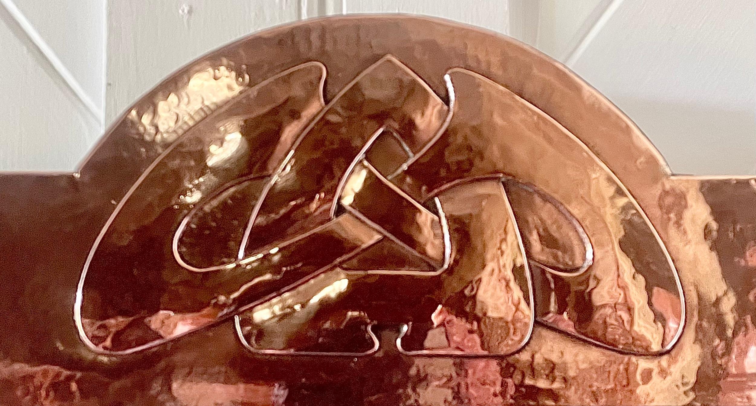 Wonderful Arts & Crafts planished copper trapezium framed mirror
With stylised Celtic knot design to the top and riveted construction
Designed by Archibald Knox
For Liberty & Co
Circa 1900

“The design is a fine example of the stylisation of a motif