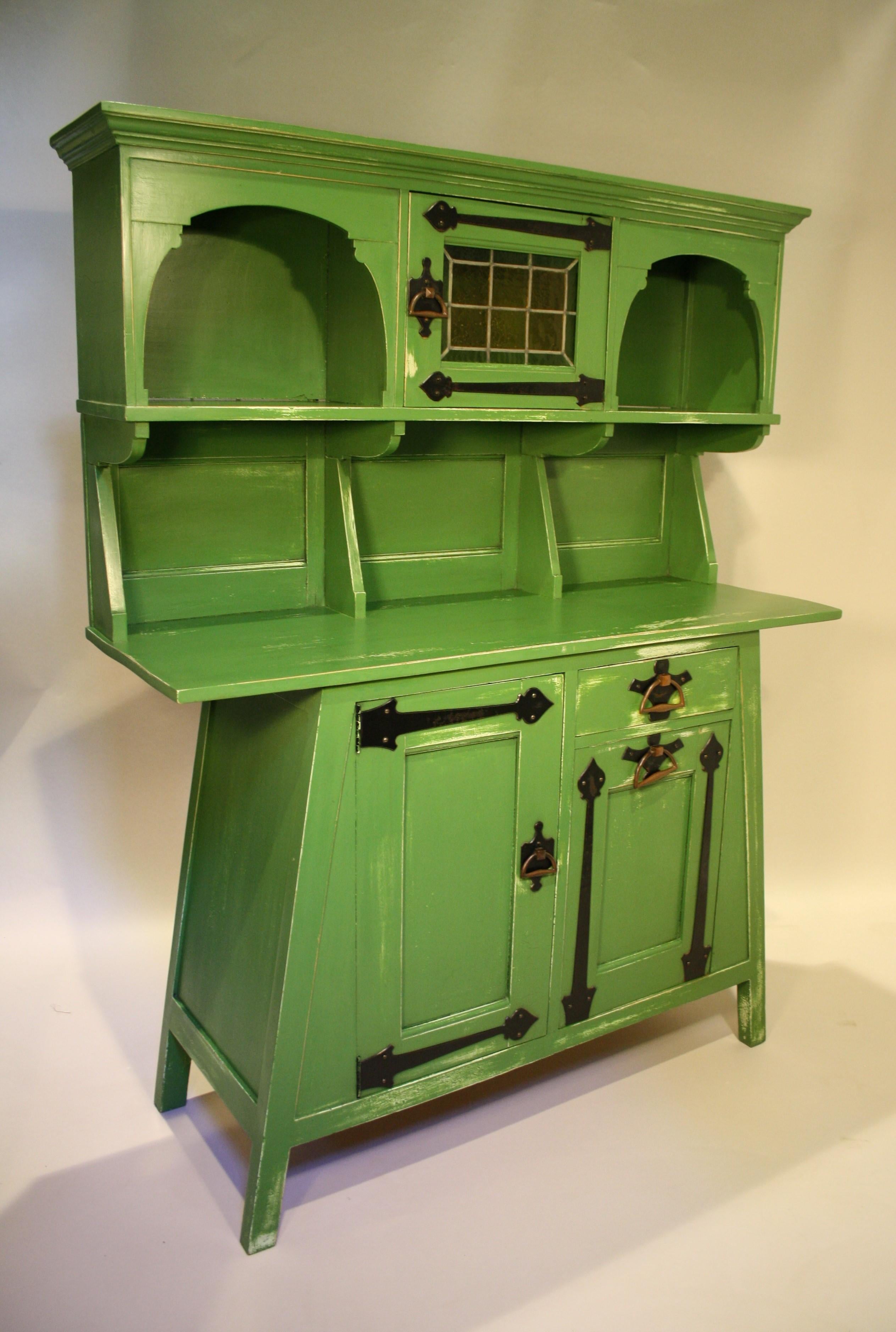 Very special Arts & Crafts cabinet from Leonard Wyburd made from a soft fruit wood.
This type of wood was used for painted furniture and in this case designed for a kitchen.
Similar designs are known but from a different type of wood previously
