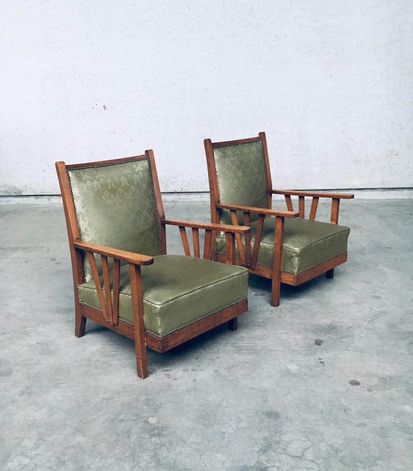 Vintage Arts & Crafts Design Period Lounge Chair set of 2. Made in Belgium, 1930's period. Oak constructed arm chairs with kaki green faux leather imprinted skai seat and back finished with brass studs. The green skai has a relief fleur imprint.