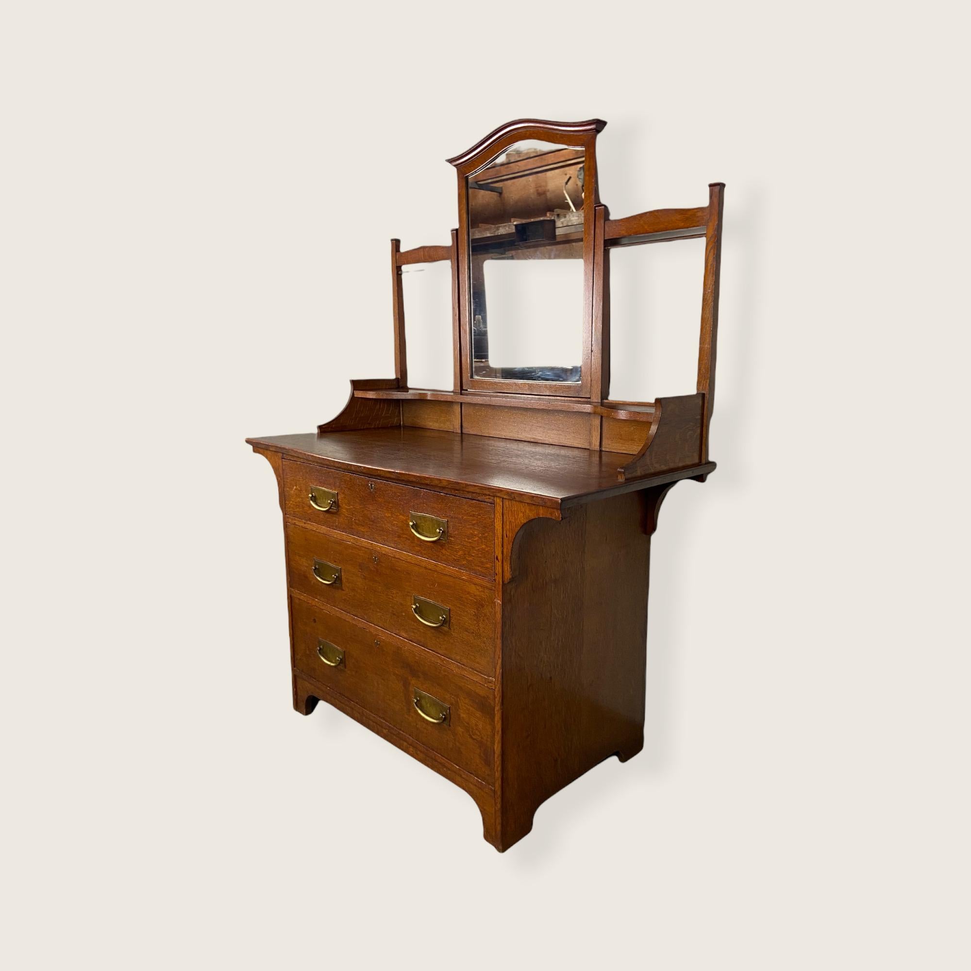 Arts & Crafts Dressing table from the company “Liberty & Co London”. Made of oak in the 1900s in England. Liberty & Co was found in 1875 and served as a vanguard for progressive, innovative design while responding to the demand for fashionable
