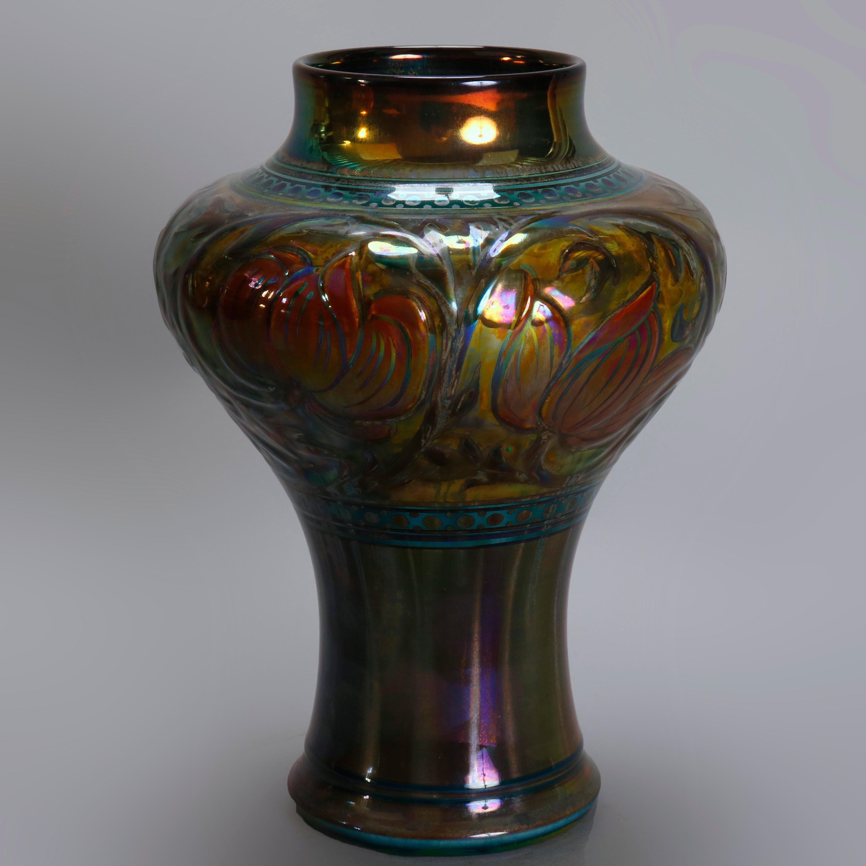 An antique Arts & Crafts English art pottery vase by Pilkington offers bulbous form with embossed band of repeating stylized floral decoration on green ground with iridized finish, signed on base as photographed, 20th century

Measures: 9.5