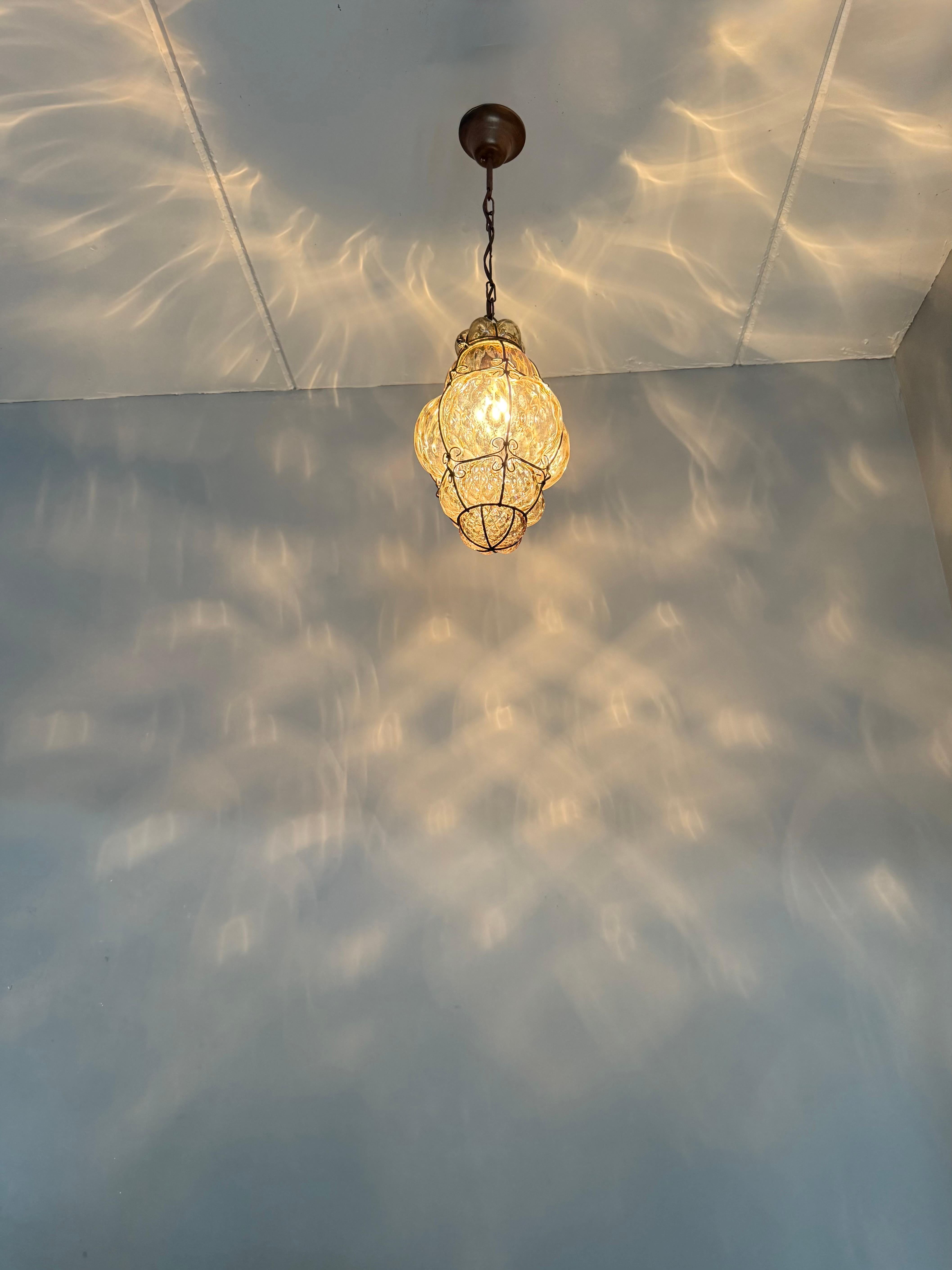 Italian Arts & Crafts Era Venetian Pendant Light of Mouthblown Glass into an Iron Frame For Sale
